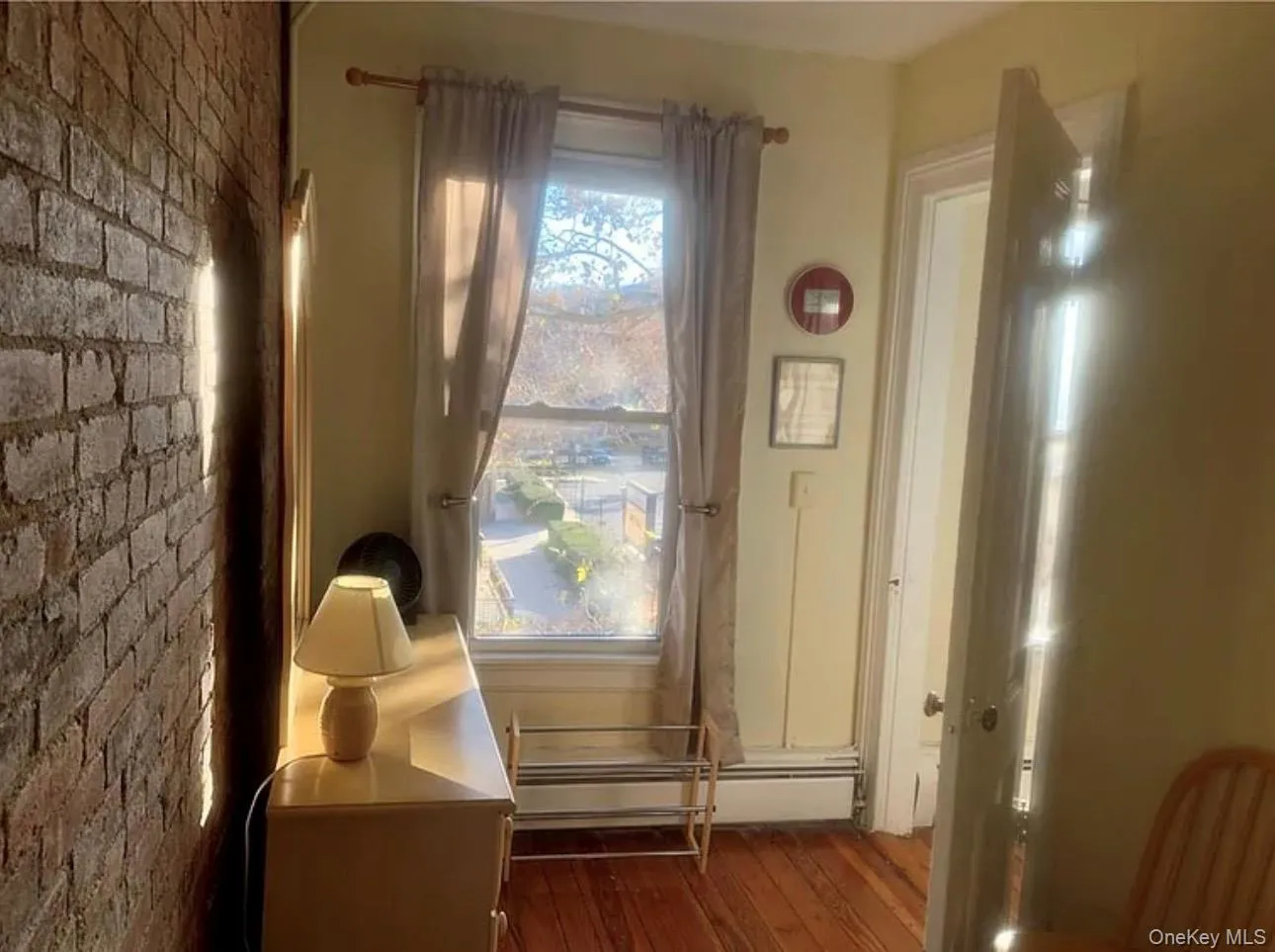 Doorway featuring hardwood / wood-style floors and a baseboard radiator Doorway featuring hardwood / wood-style floors and a baseboard radiator