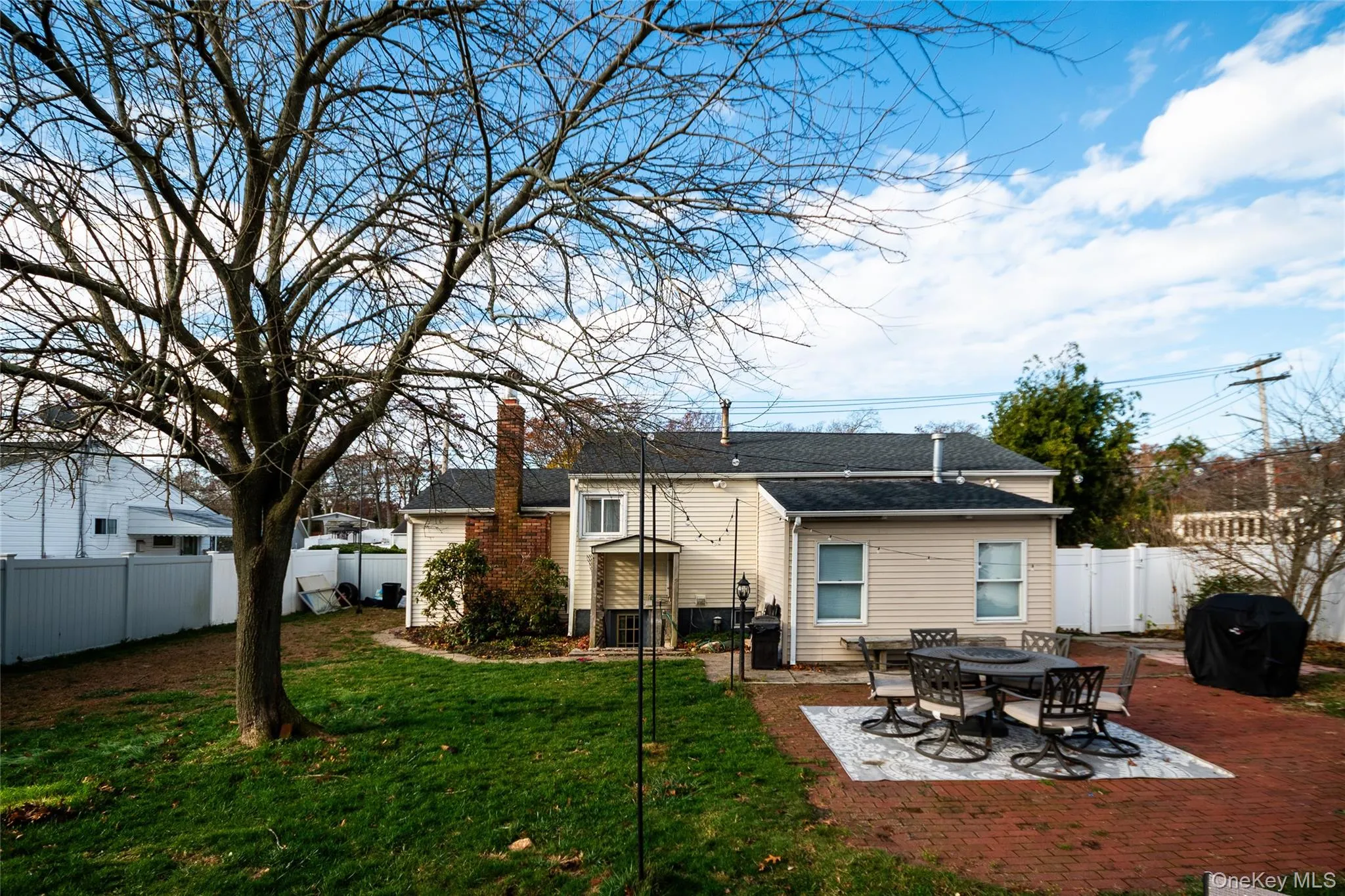 Back of property with a patio area, a fenced backyard, and a chimney Back of property with a patio area, a fenced backyard, and a chimney