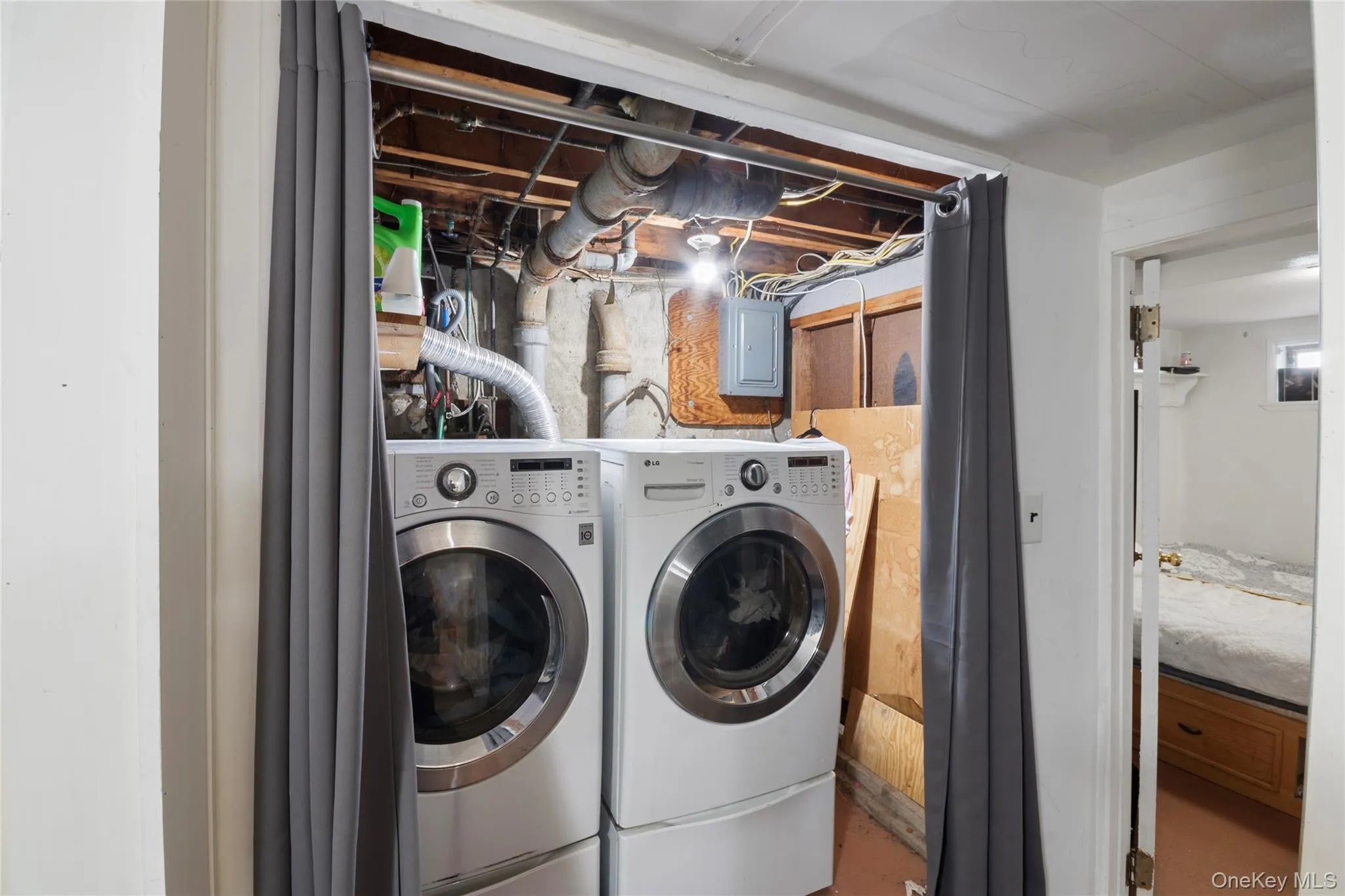 Laundry area with electric panel and independent washer and dryer Laundry area with electric panel and independent washer and dryer