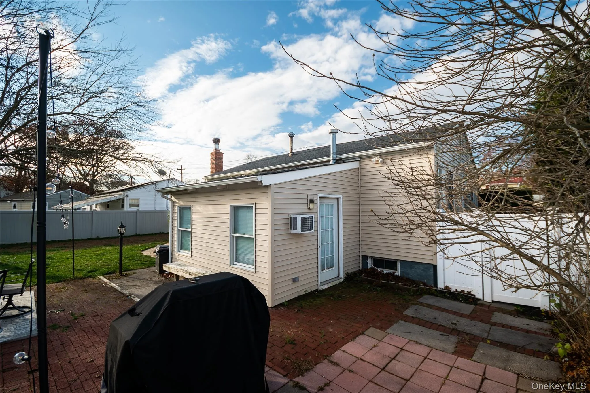 Rear view of property with a patio area and a chimney Rear view of property with a patio area and a chimney