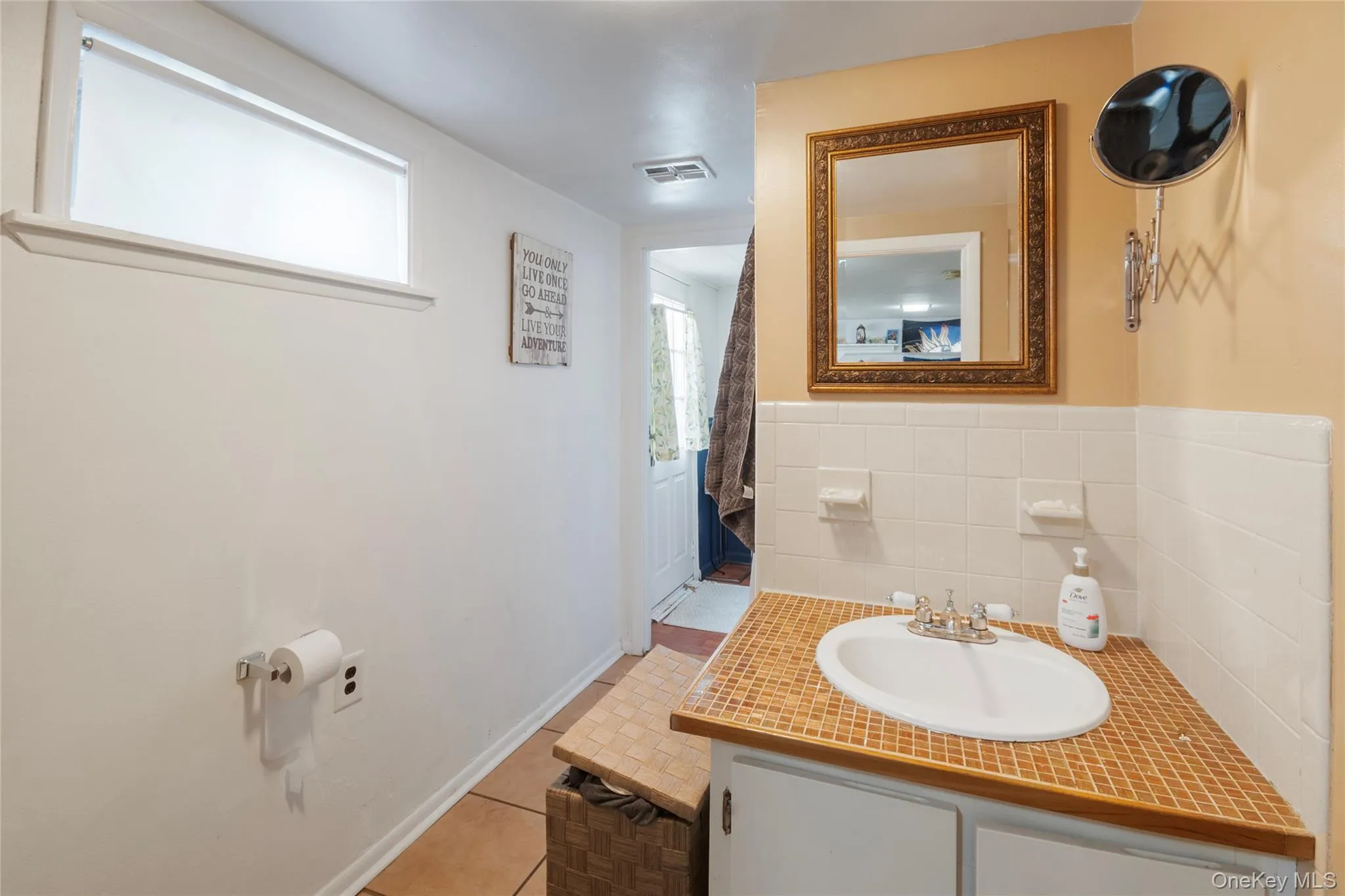 Bathroom featuring vanity and light tile patterned flooring Bathroom featuring vanity and light tile patterned flooring