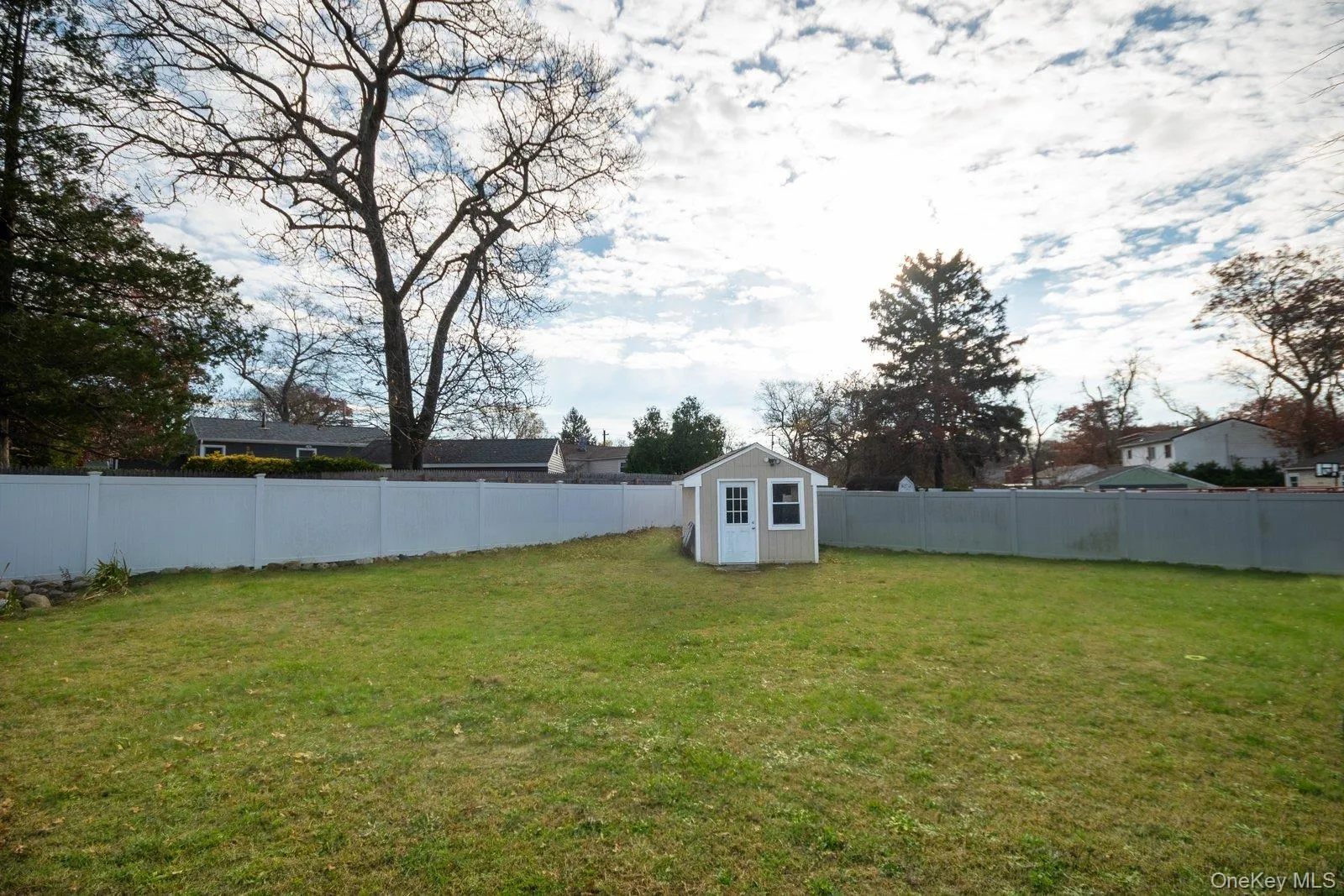 Fenced backyard featuring a storage unit Fenced backyard featuring a storage unit
