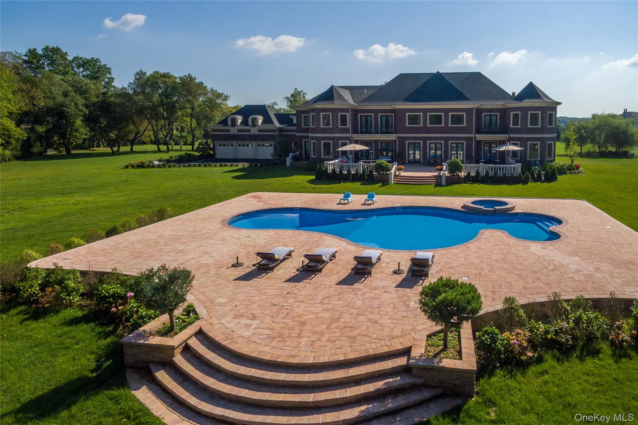View of pool featuring a yard, a patio area, a deck, and a pool with connected hot tub View of pool featuring a yard, a patio area, a deck, and a pool with connected hot tub