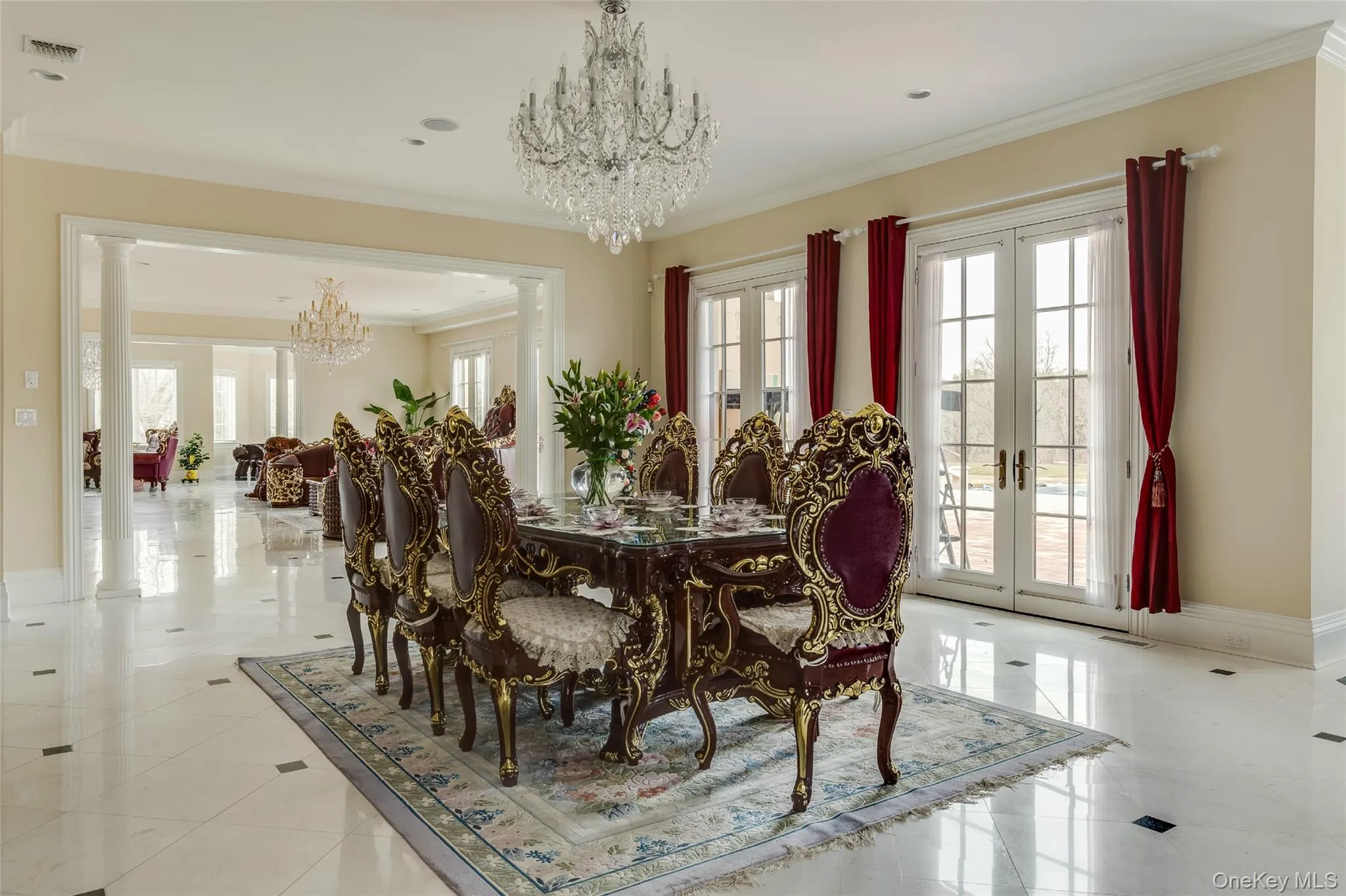 Dining room featuring french doors, decorative columns, a chandelier, and crown molding Dining room featuring french doors, decorative columns, a chandelier, and crown molding