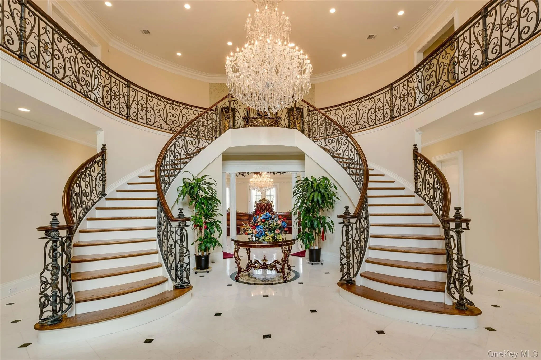 Stairs featuring a chandelier, ornamental molding, recessed lighting, and a high ceiling Stairs featuring a chandelier, ornamental molding, recessed lighting, and a high ceiling