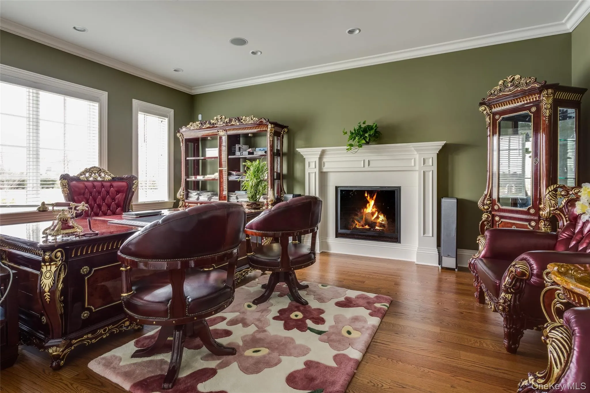 Sitting room with hardwood / wood-style floors, a warm lit fireplace, crown molding, and recessed lighting Sitting room with hardwood / wood-style floors, a warm lit fireplace, crown molding, and recessed lighting