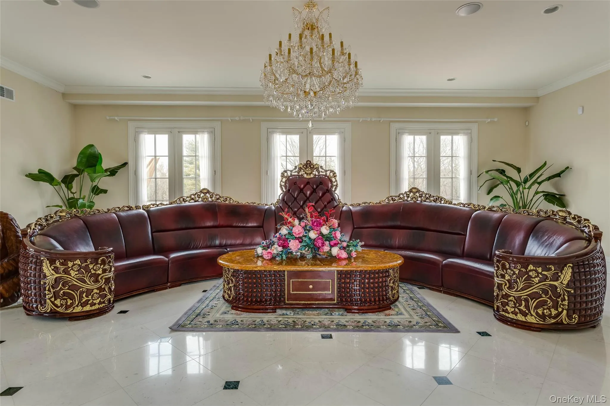 Tiled living area featuring ornamental molding, a chandelier, and healthy amount of natural light Tiled living area featuring ornamental molding, a chandelier, and healthy amount of natural light