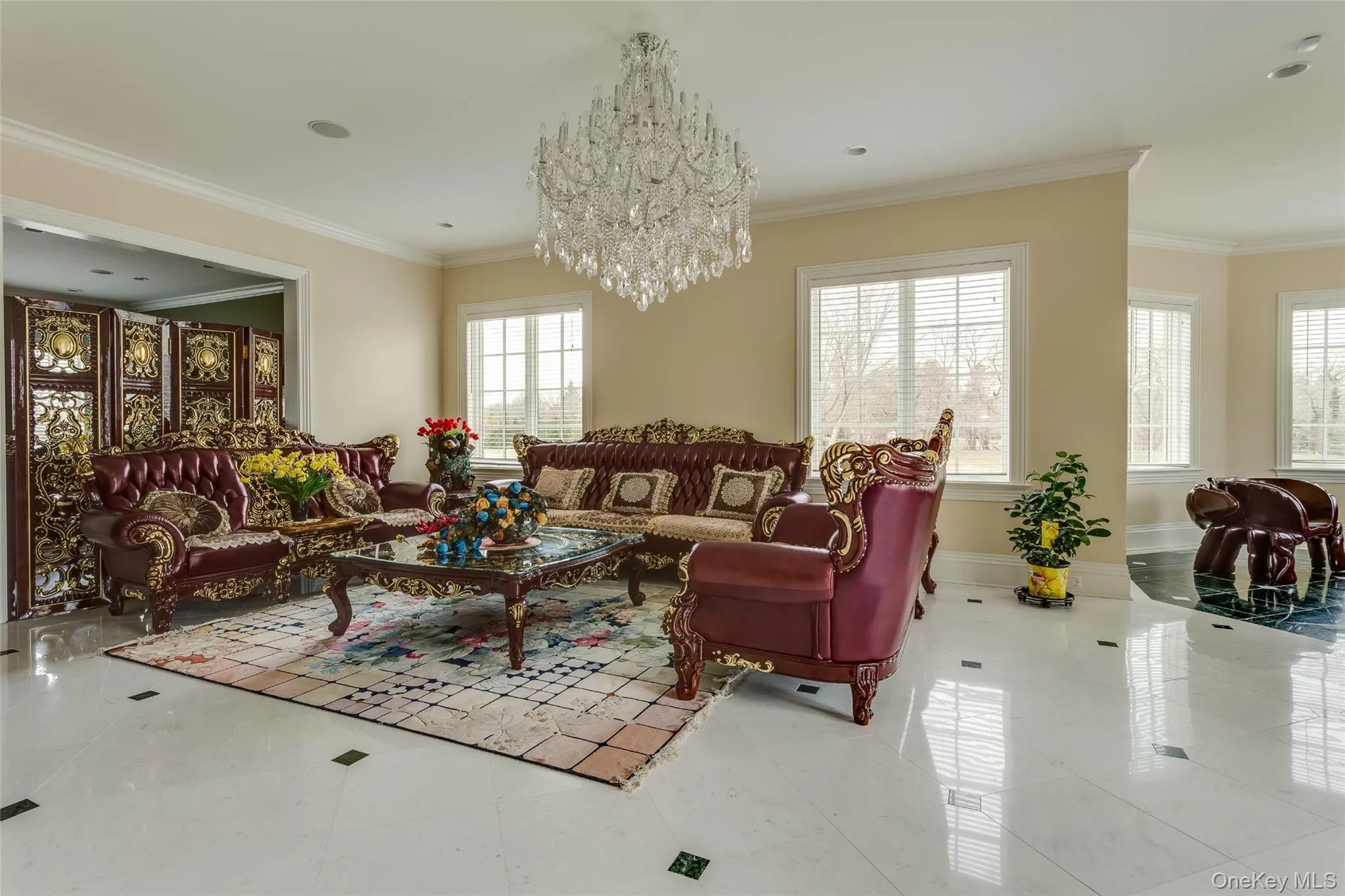 Tiled living area featuring crown molding, a chandelier, and recessed lighting Tiled living area featuring crown molding, a chandelier, and recessed lighting