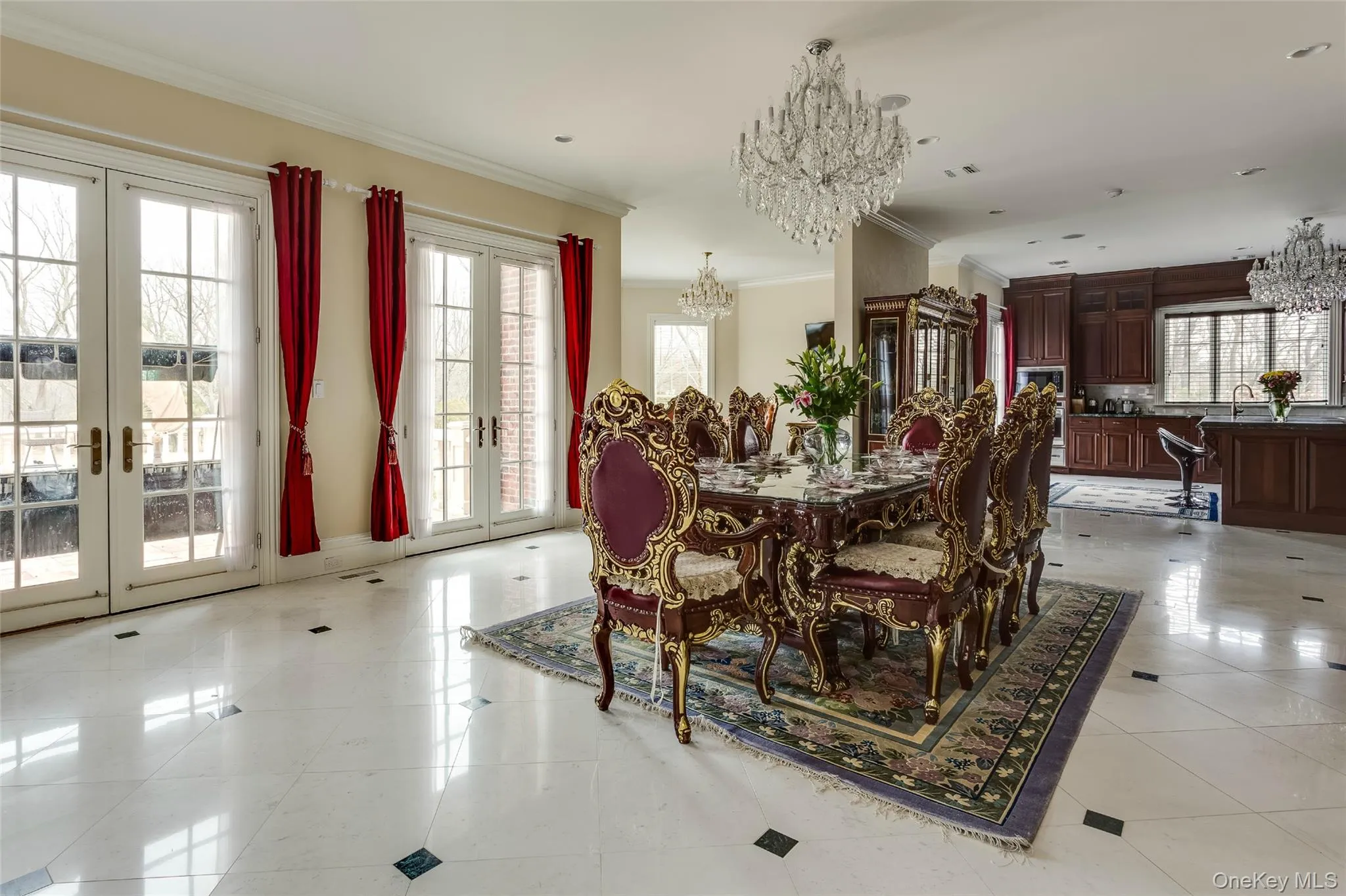 Dining room featuring a chandelier, french doors, light tile patterned floors, healthy amount of natural light, and ornamental molding Dining room featuring a chandelier, french doors, light tile patterned floors, healthy amount of natural light, and ornamental molding