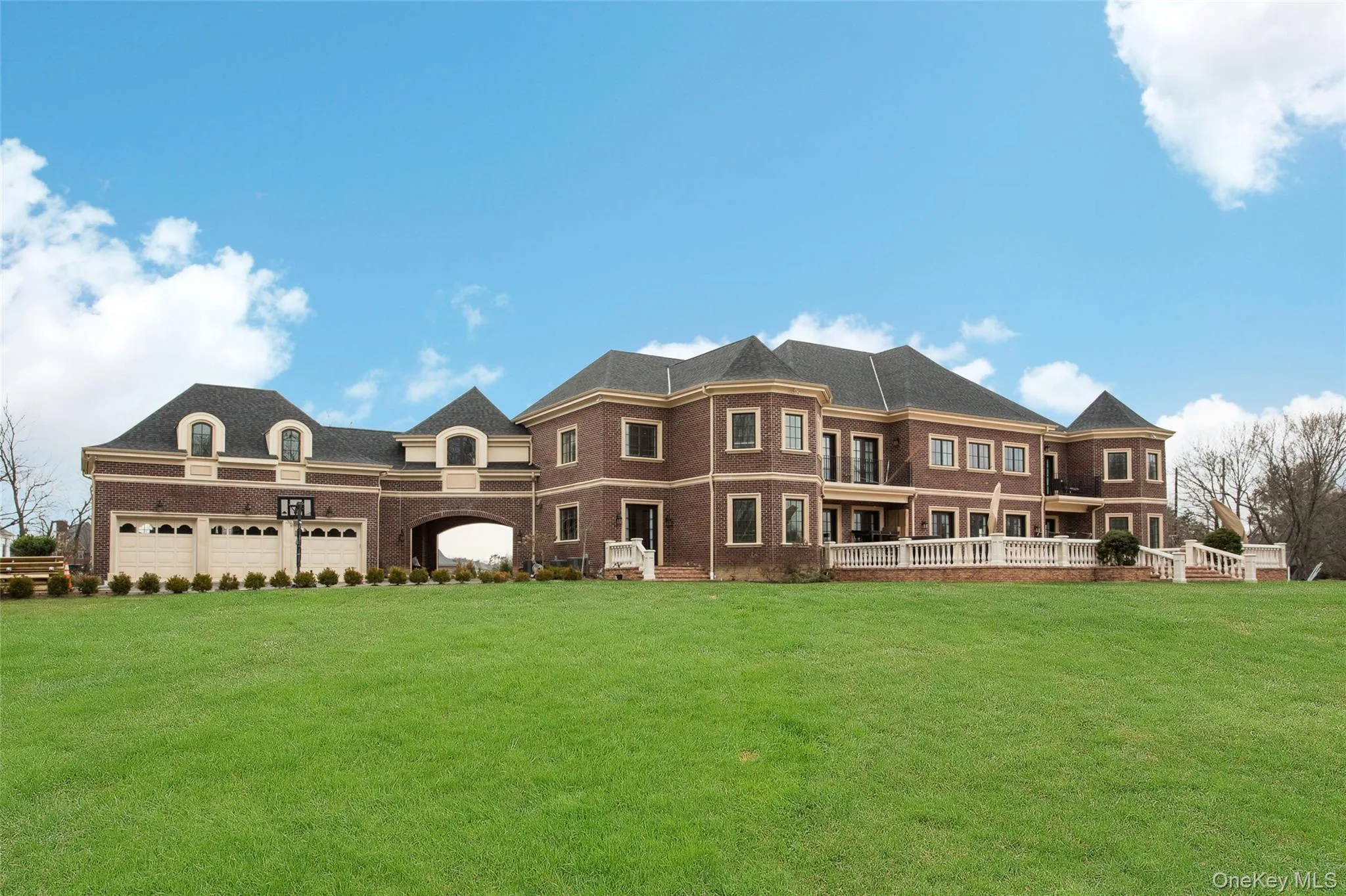 Back of property featuring a lawn and a garage Back of property featuring a lawn and a garage