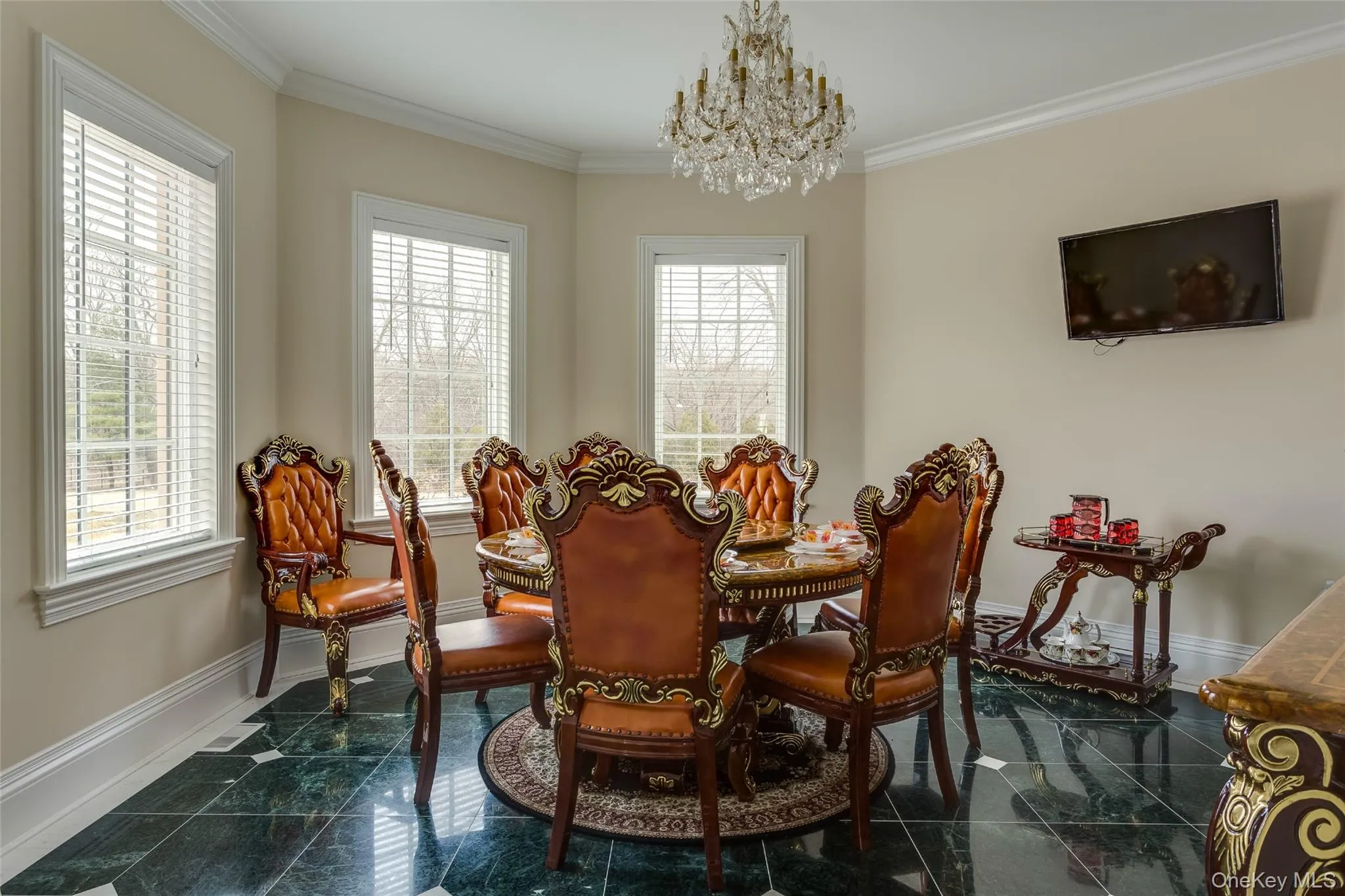 Dining room featuring granite floors, a chandelier, and crown molding Dining room featuring granite floors, a chandelier, and crown molding