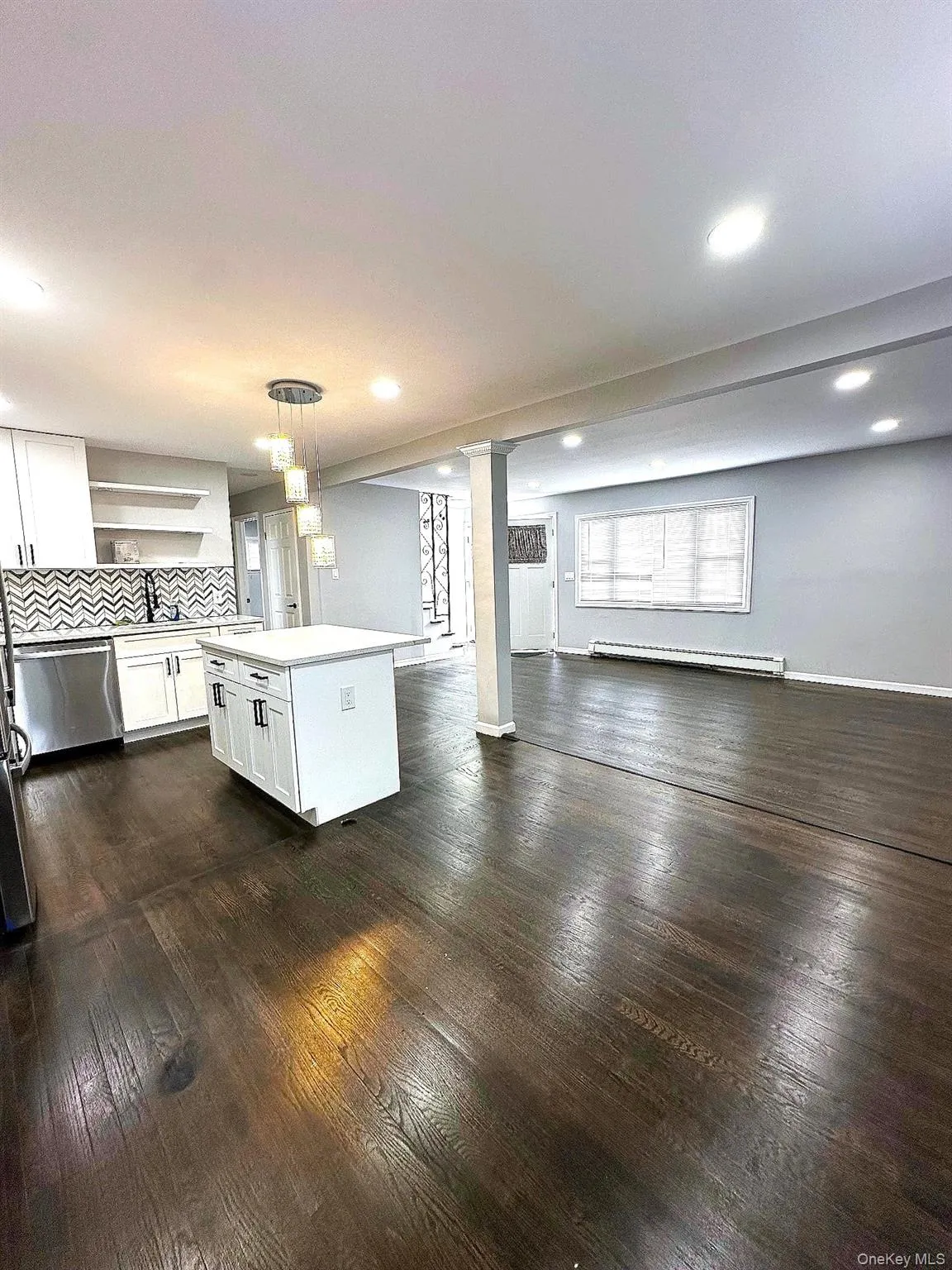 Kitchen with white cabinets, open shelves, pendant lighting, a kitchen island, and open floor plan Kitchen with white cabinets, open shelves, pendant lighting, a kitchen island, and open floor plan
