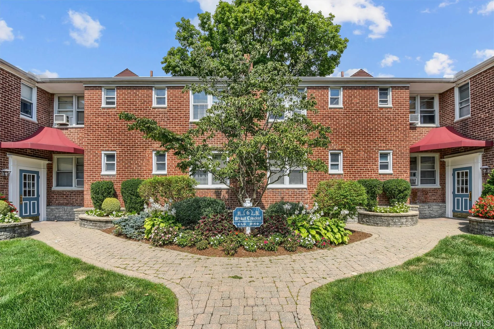 View of front of property featuring a front yard and brick siding View of front of property featuring a front yard and brick siding