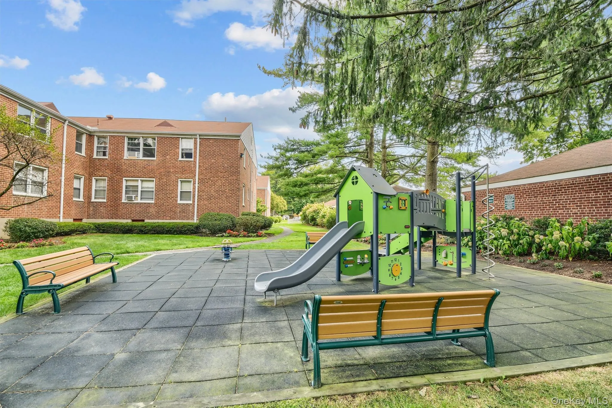 Communal playground with a yard and a patio area Communal playground with a yard and a patio area