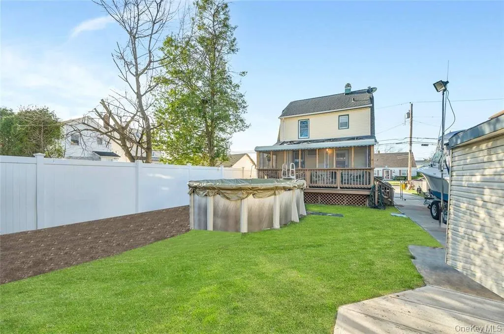 Rear view of house with a deck and a fenced backyard Rear view of house with a deck and a fenced backyard