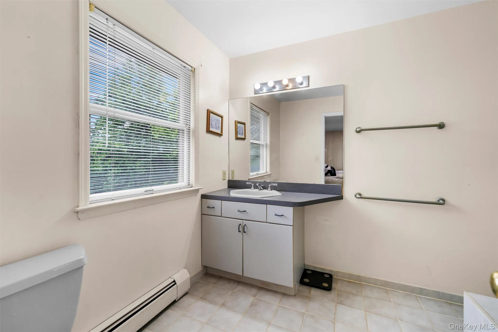 Bathroom with baseboard heating and vanity Bathroom with baseboard heating and vanity