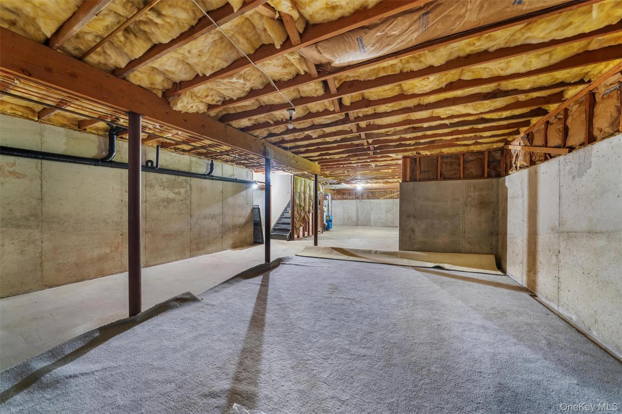 Unfinished below grade area featuring stairway Unfinished below grade area featuring stairway