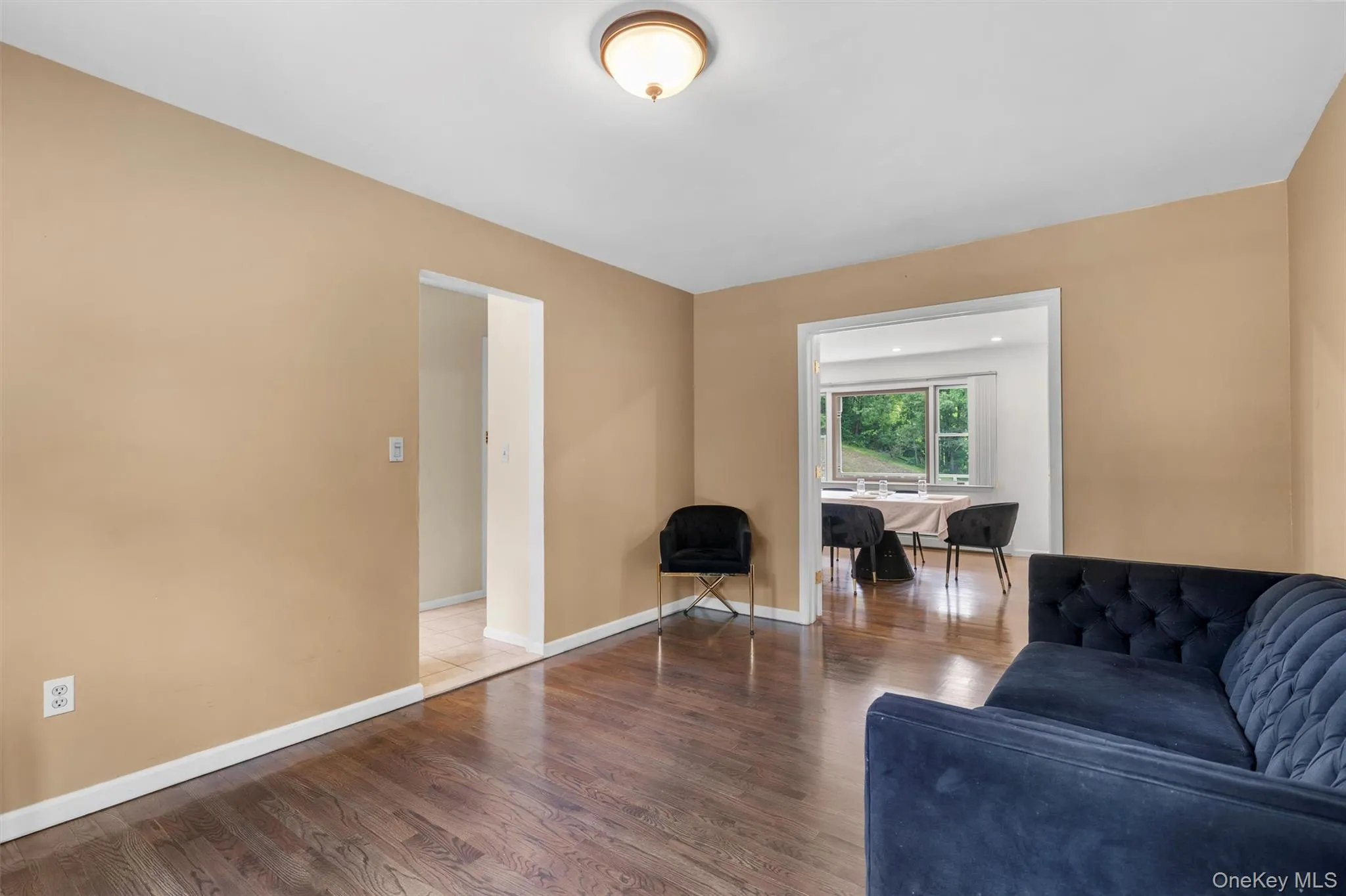 Living room featuring wood finished floors and baseboards Living room featuring wood finished floors and baseboards