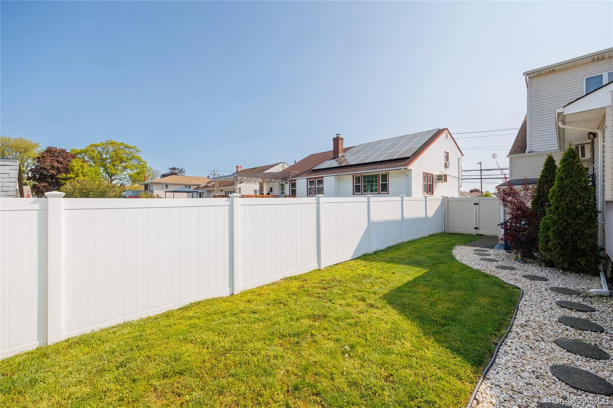 Fenced backyard with a gate Fenced backyard with a gate