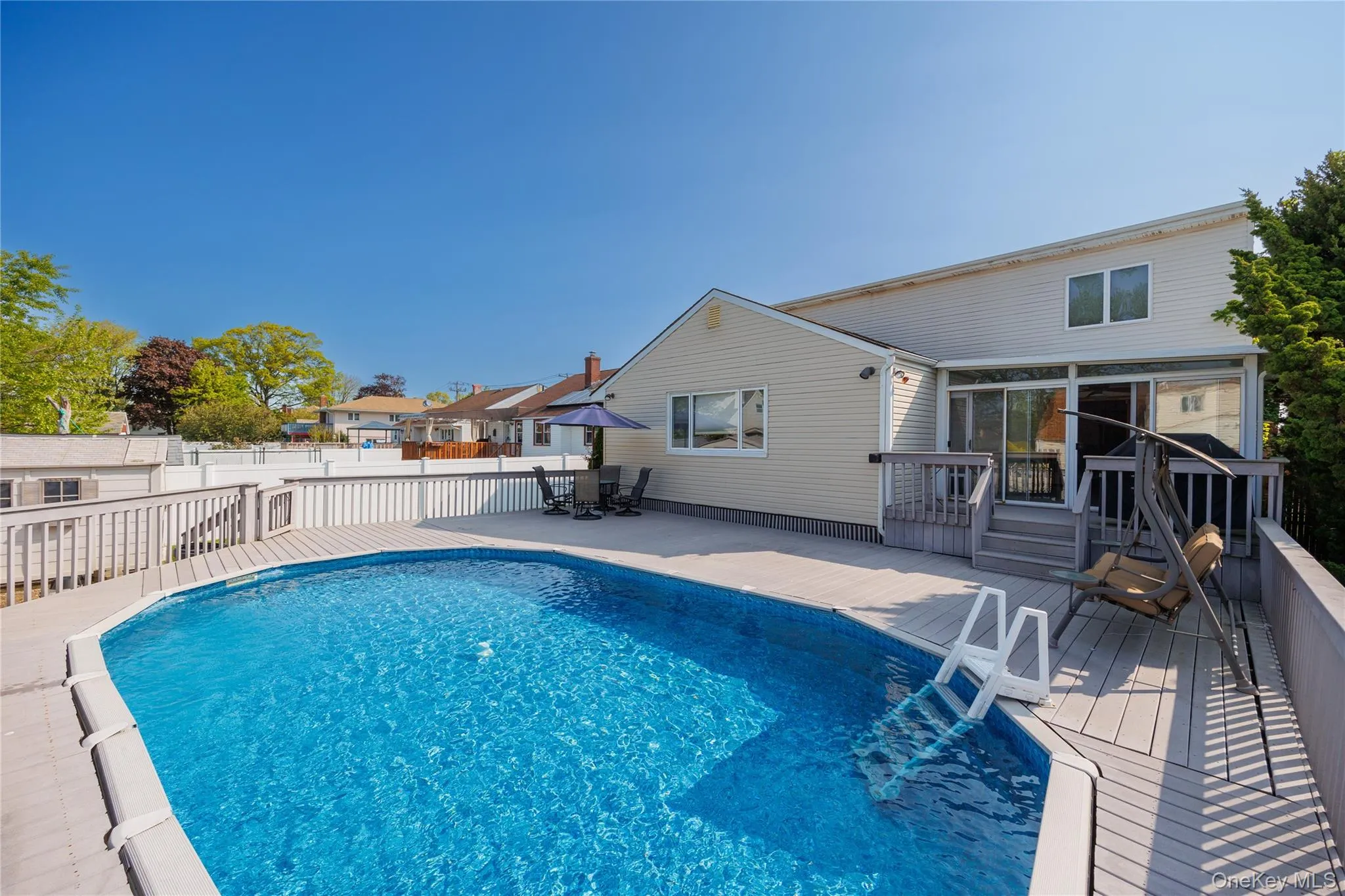 View of pool with a deck and outdoor dining space View of pool with a deck and outdoor dining space