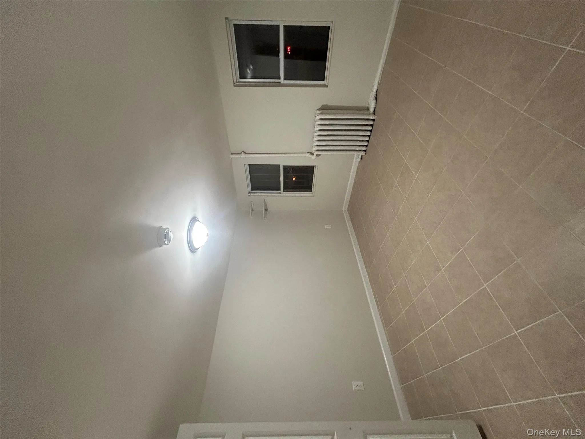 Spare room with radiator heating unit and baseboards Spare room with radiator heating unit and baseboards