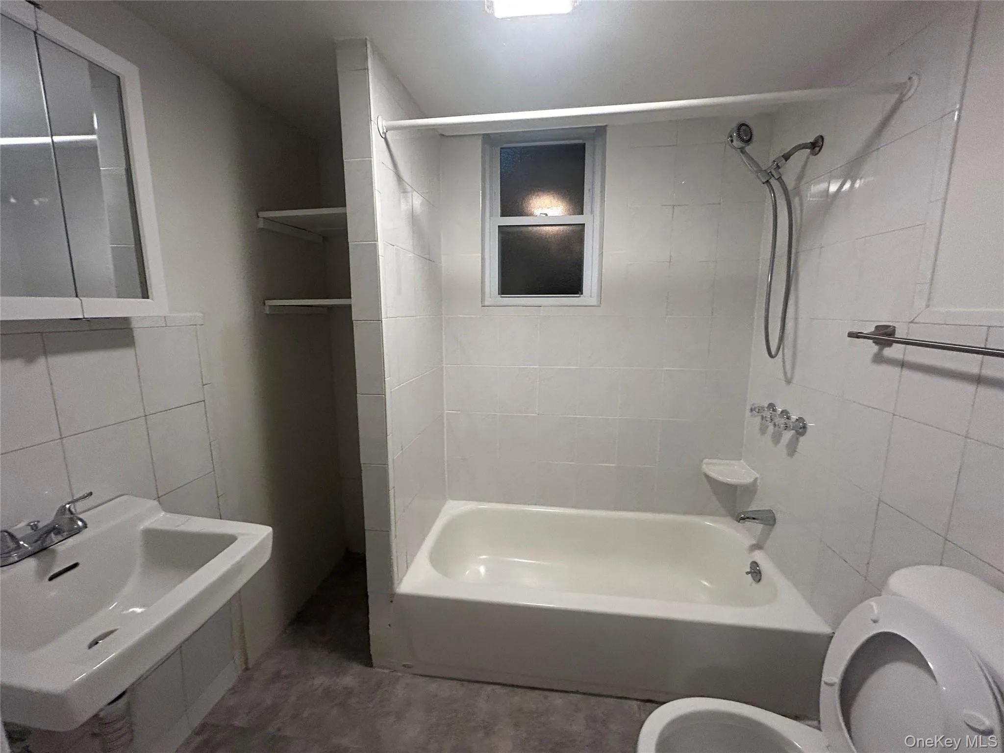 Bathroom featuring tile walls and bathtub / shower combination Bathroom featuring tile walls and bathtub / shower combination