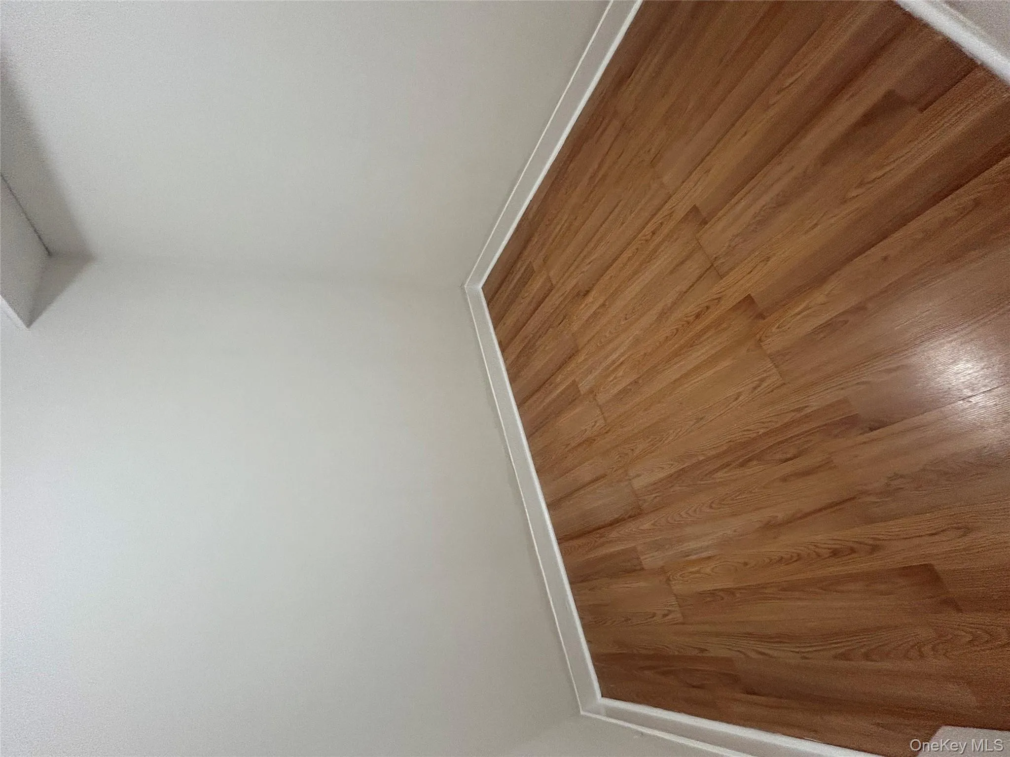 Unfurnished room featuring wood finished floors and baseboards Unfurnished room featuring wood finished floors and baseboards