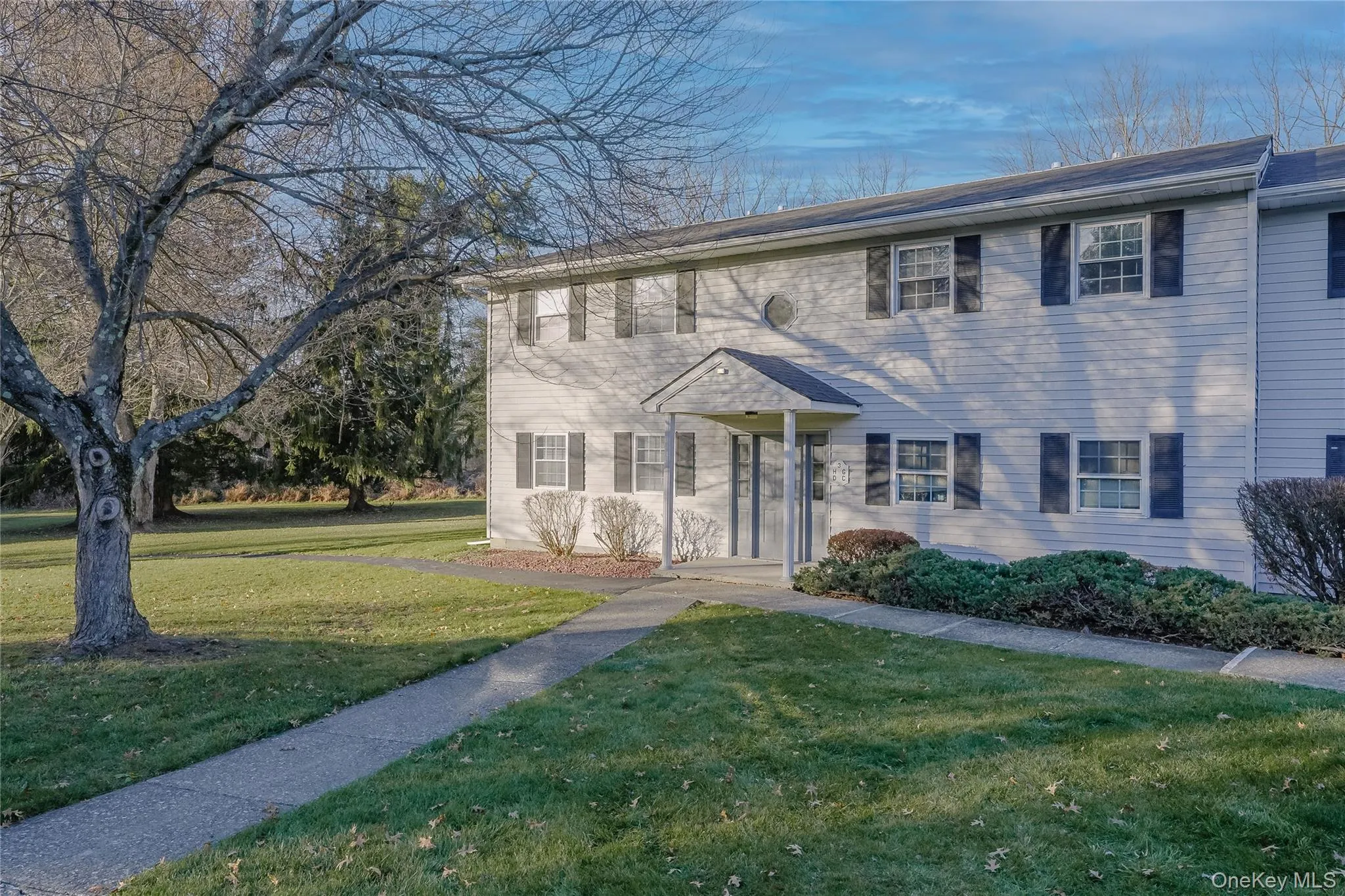 Colonial-style house featuring a front yard Colonial-style house featuring a front yard