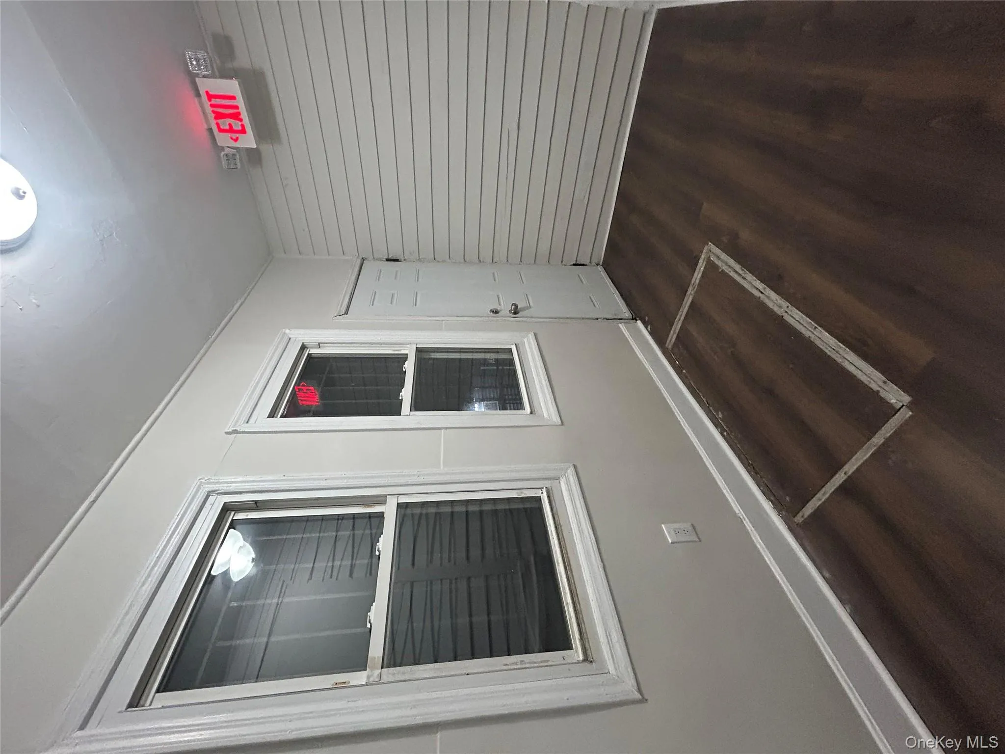 Unfurnished room featuring baseboards and dark wood-type flooring Unfurnished room featuring baseboards and dark wood-type flooring