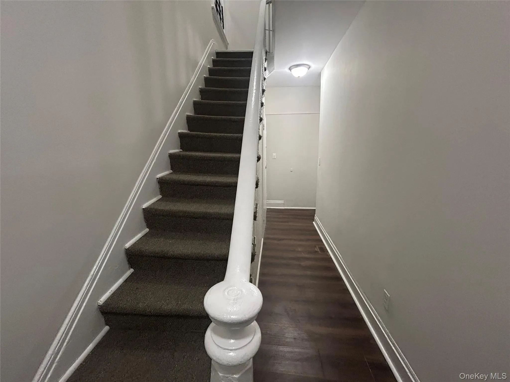 Stairs with baseboards and wood finished floors Stairs with baseboards and wood finished floors