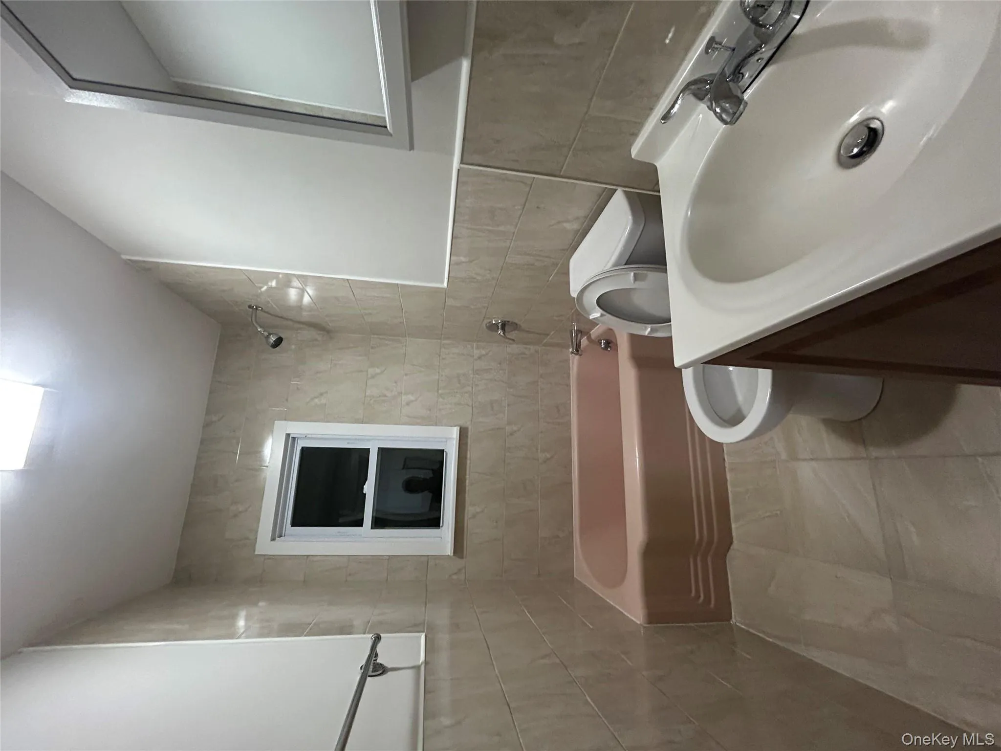 Bathroom with tile walls, shower / tub combination, vanity, and tile patterned flooring Bathroom with tile walls, shower / tub combination, vanity, and tile patterned flooring