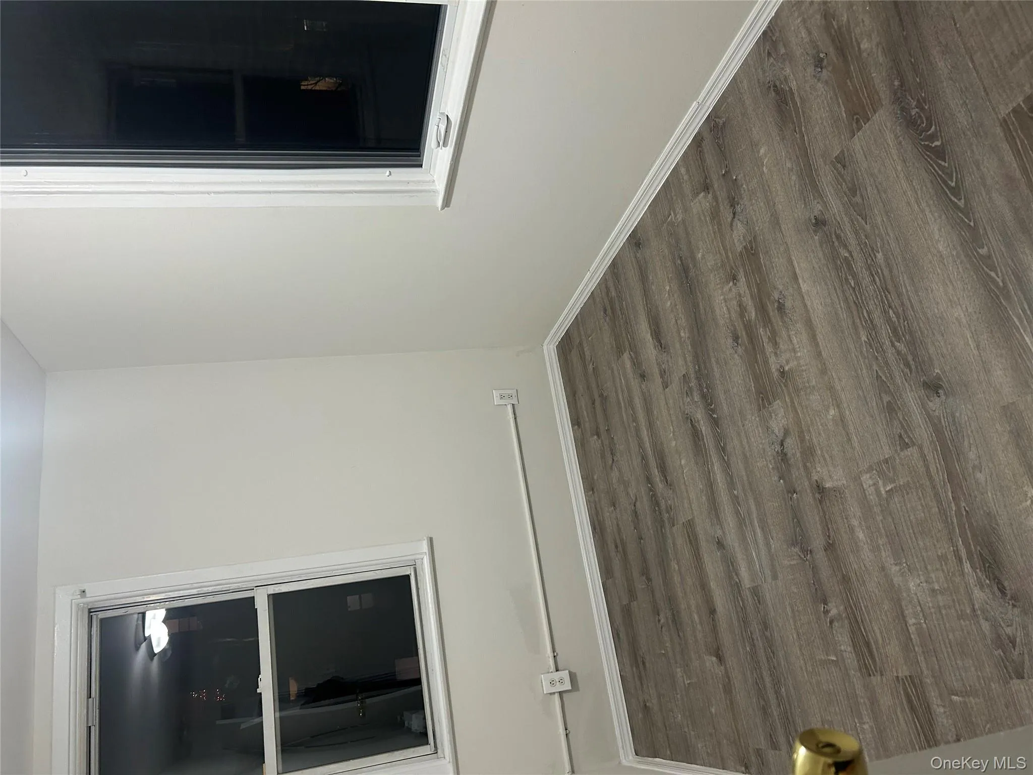 Spare room with dark wood finished floors and baseboards Spare room with dark wood finished floors and baseboards