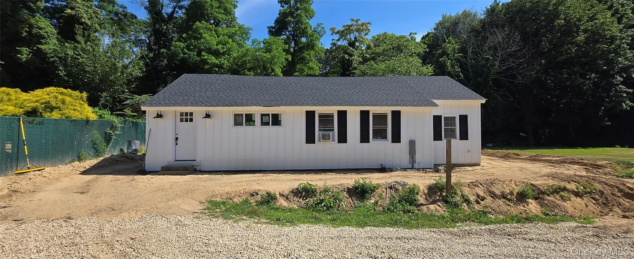View of front of house featuring an outbuilding and a shingled roof View of front of house featuring an outbuilding and a shingled roof