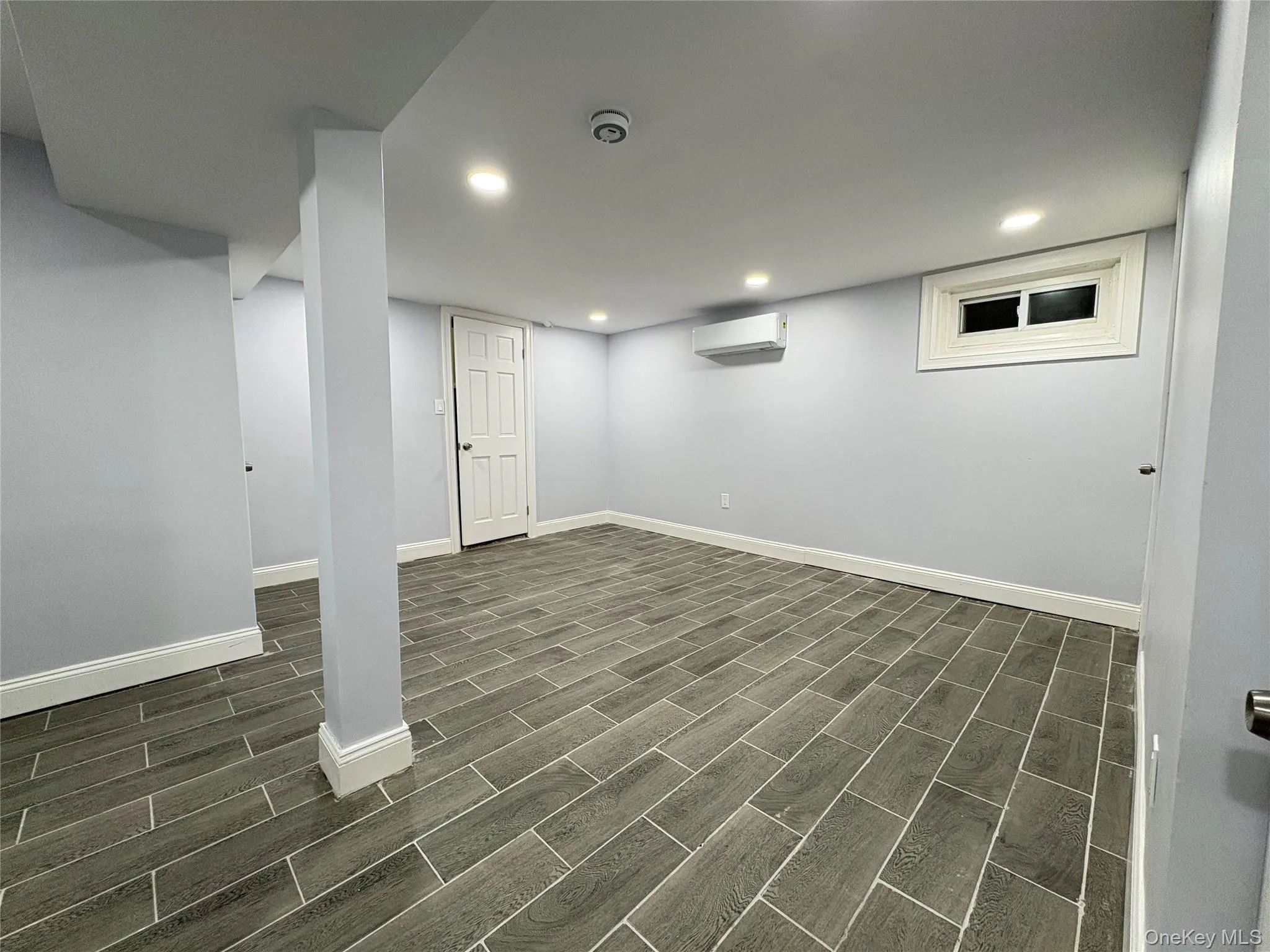 Finished below grade area with wood finish floors and recessed lighting Finished below grade area with wood finish floors and recessed lighting