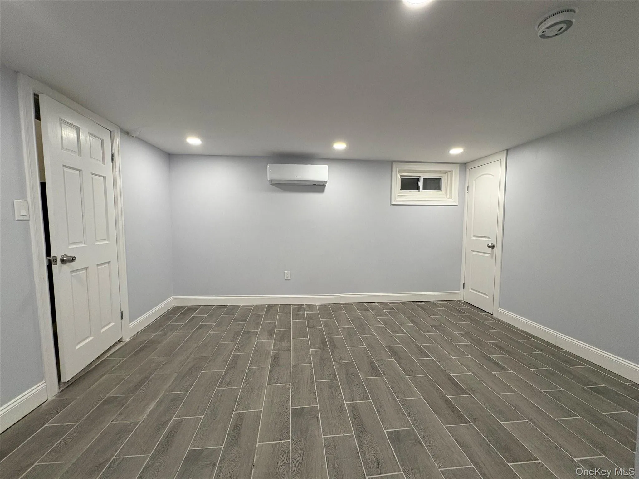 Finished basement featuring wood tiled floors and recessed lighting Finished basement featuring wood tiled floors and recessed lighting