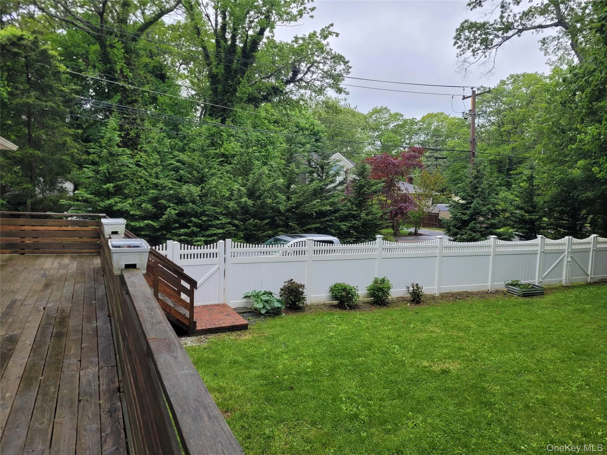 Fenced backyard featuring a wooden deck Fenced backyard featuring a wooden deck