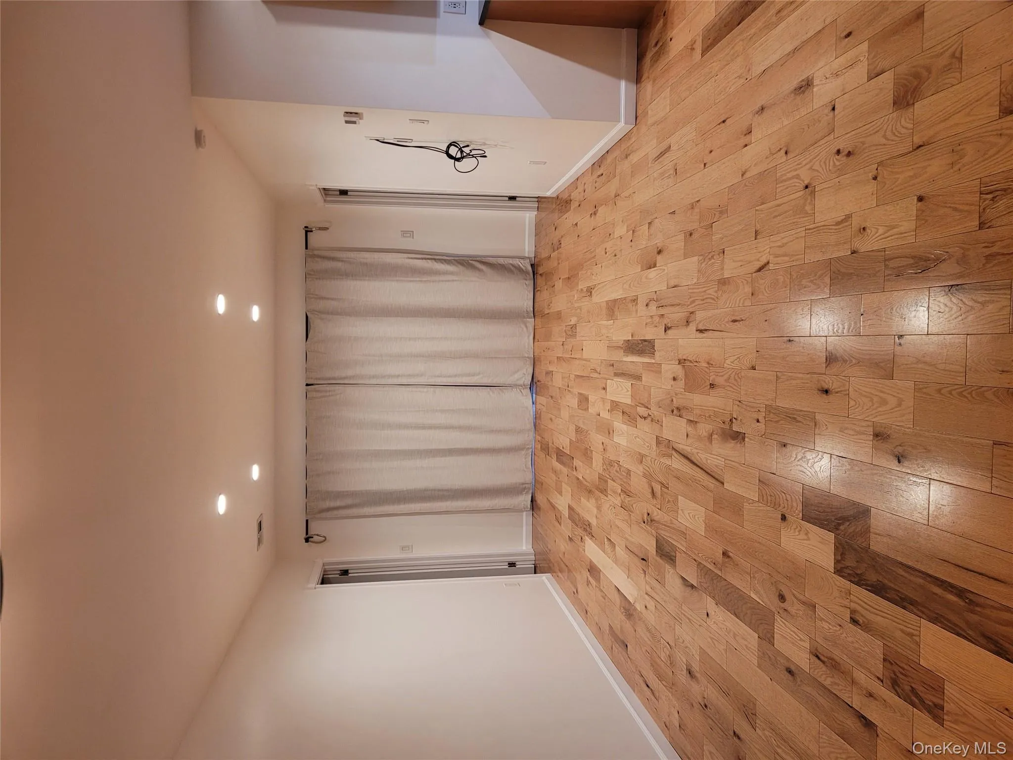 Empty room with light wood finished floors and recessed lighting Empty room with light wood finished floors and recessed lighting