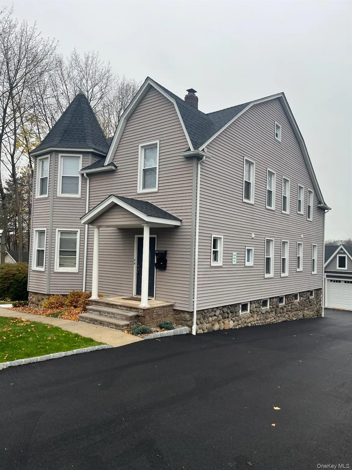 View of front of house with a shingled roof, a chimney, a garage, and a gambrel roof View of front of house with a shingled roof, a chimney, a garage, and a gambrel roof