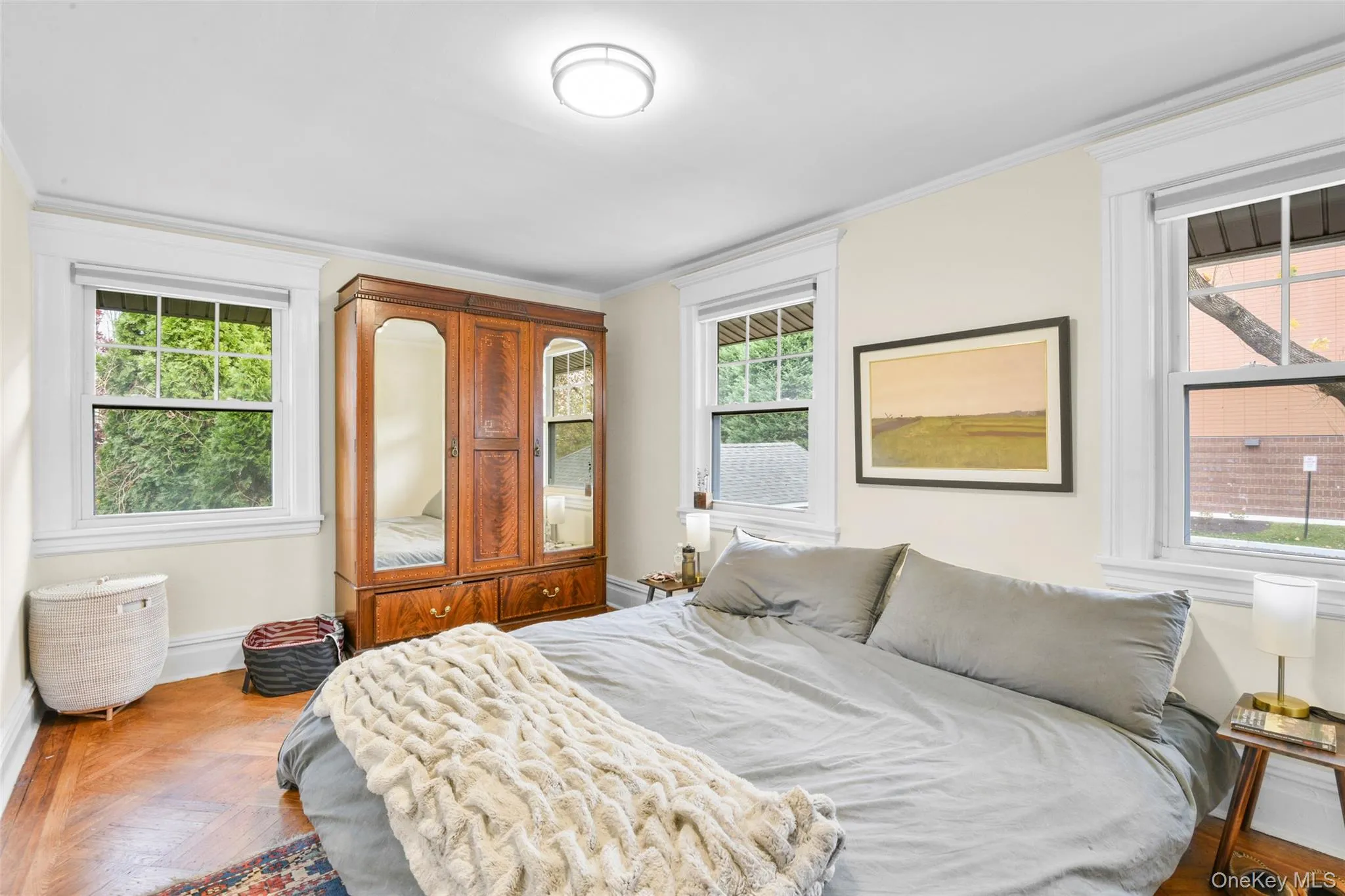 Bedroom with multiple windows and crown molding Bedroom with multiple windows and crown molding