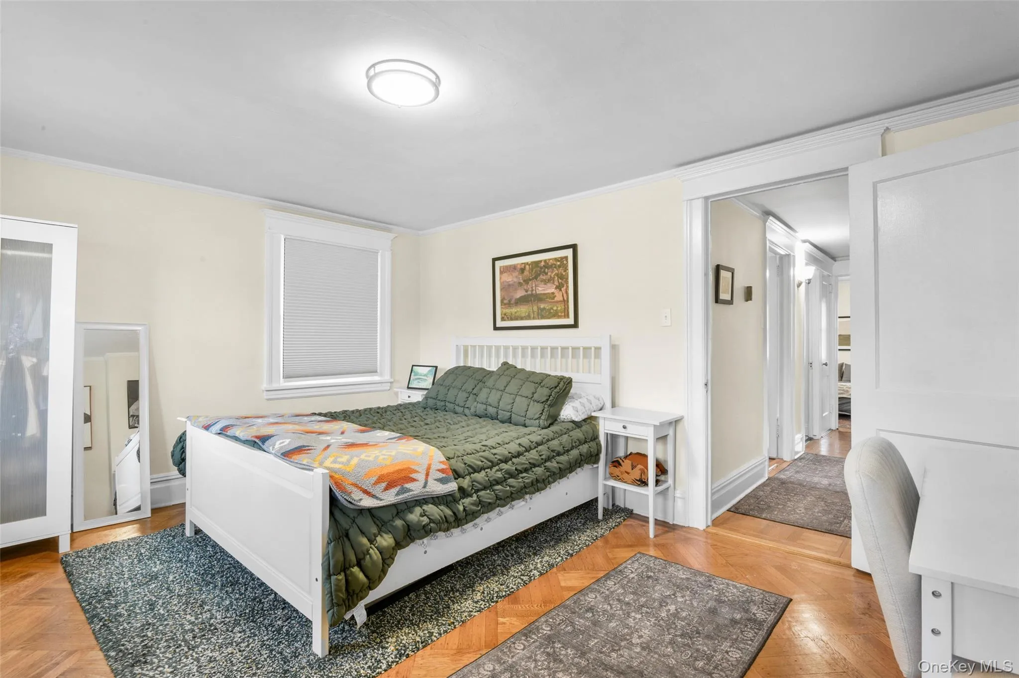 Bedroom featuring ornamental molding and baseboards Bedroom featuring ornamental molding and baseboards