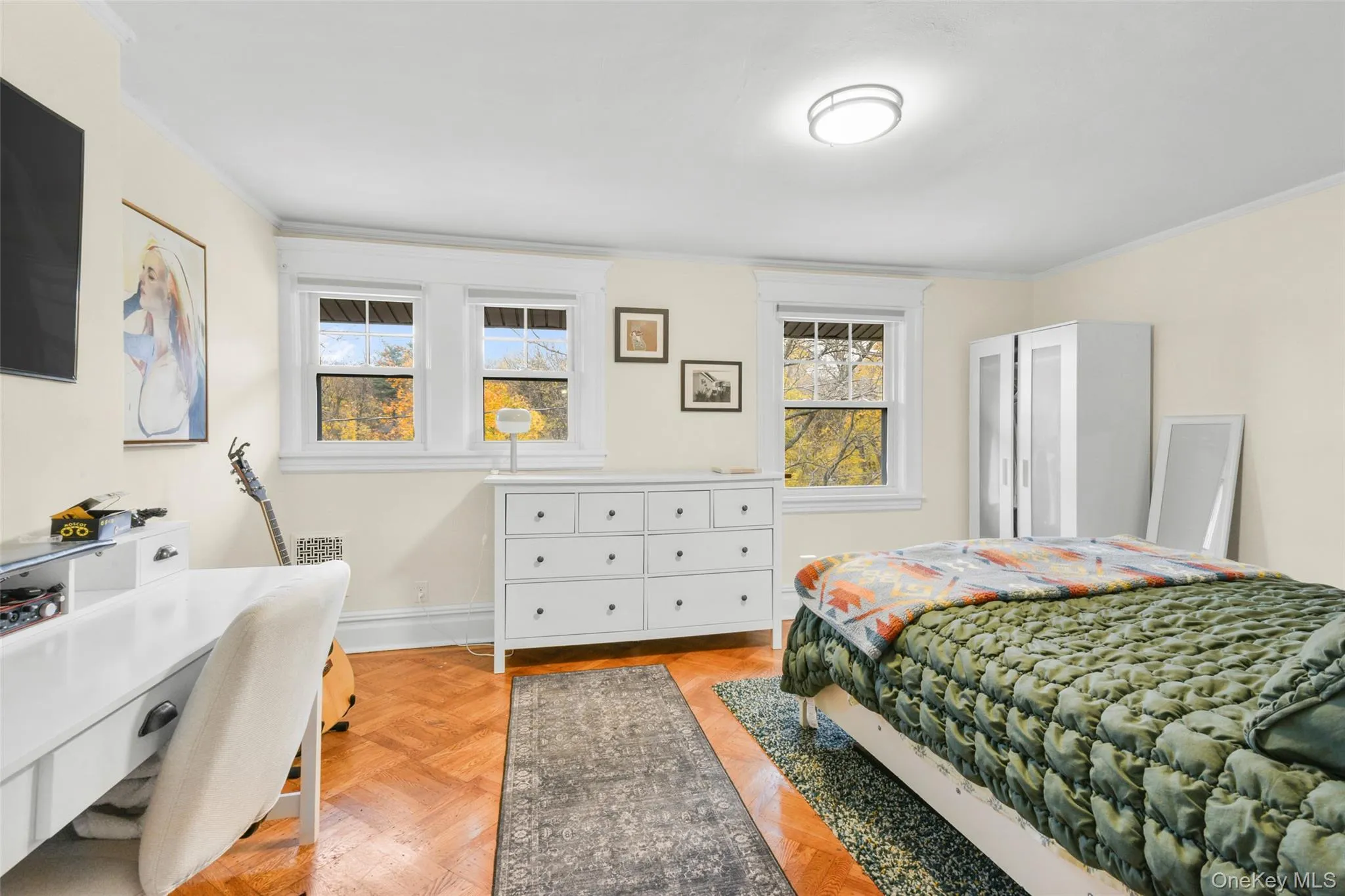 Bedroom featuring multiple windows and crown molding Bedroom featuring multiple windows and crown molding