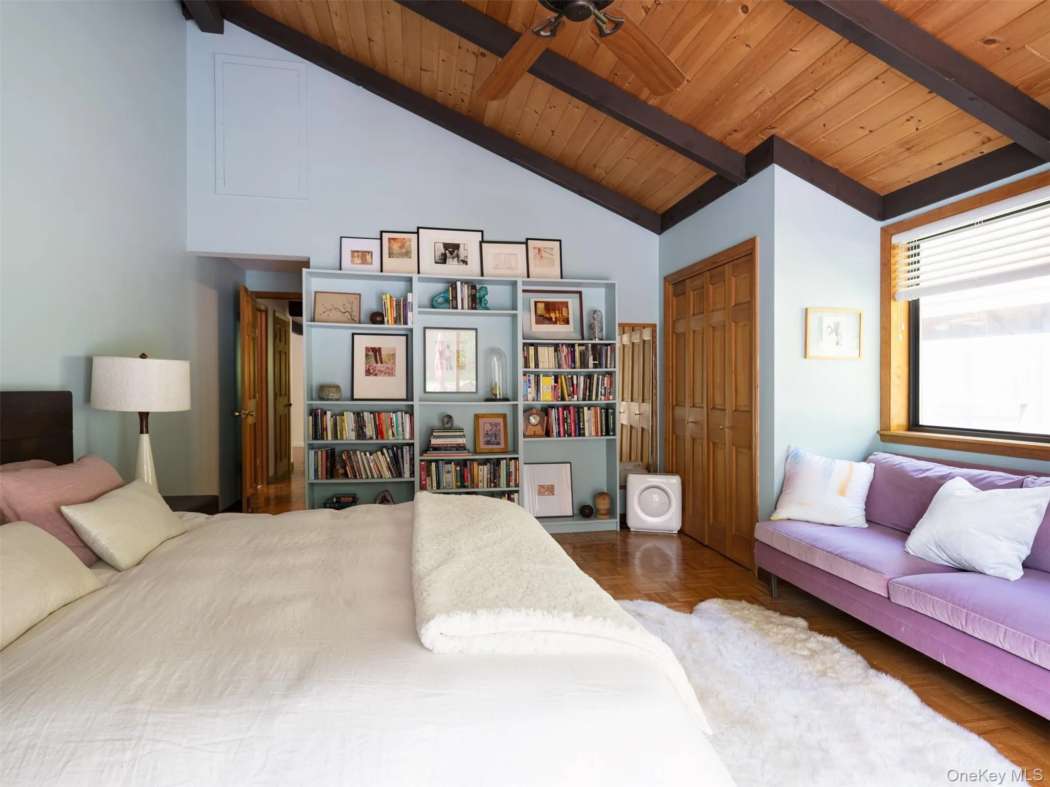 Bedroom with a wood ceiling with exposed beams, a closet, and high vaulted ceiling Bedroom with a wood ceiling with exposed beams, a closet, and high vaulted ceiling