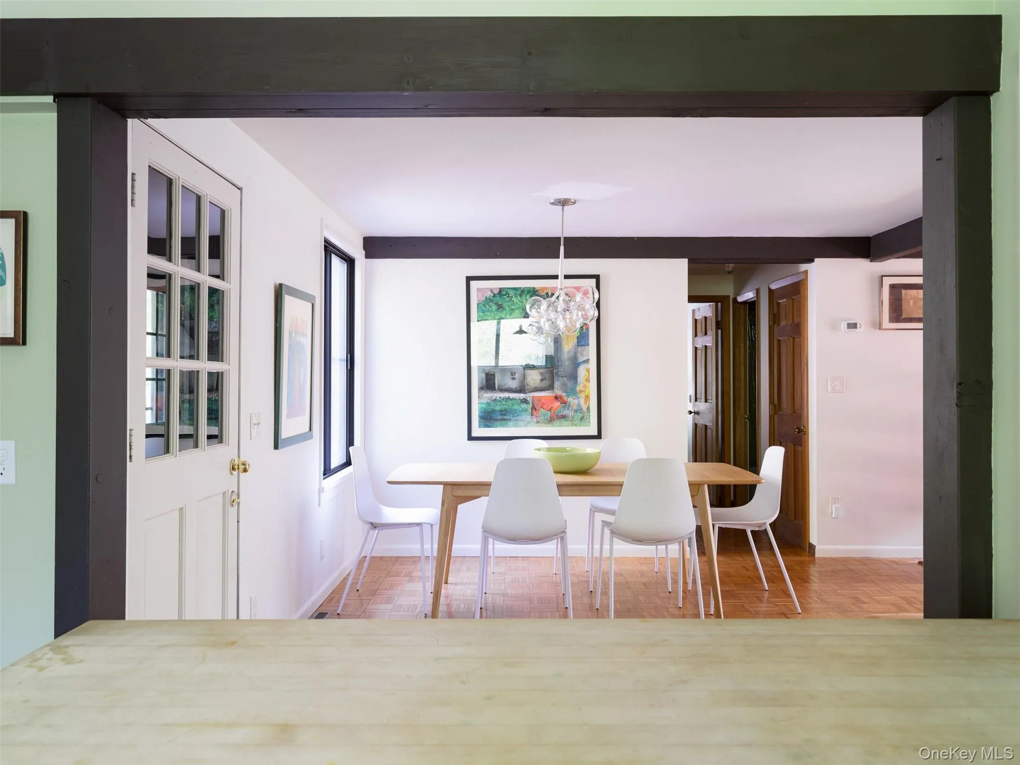 Dining space featuring baseboards and a chandelier Dining space featuring baseboards and a chandelier