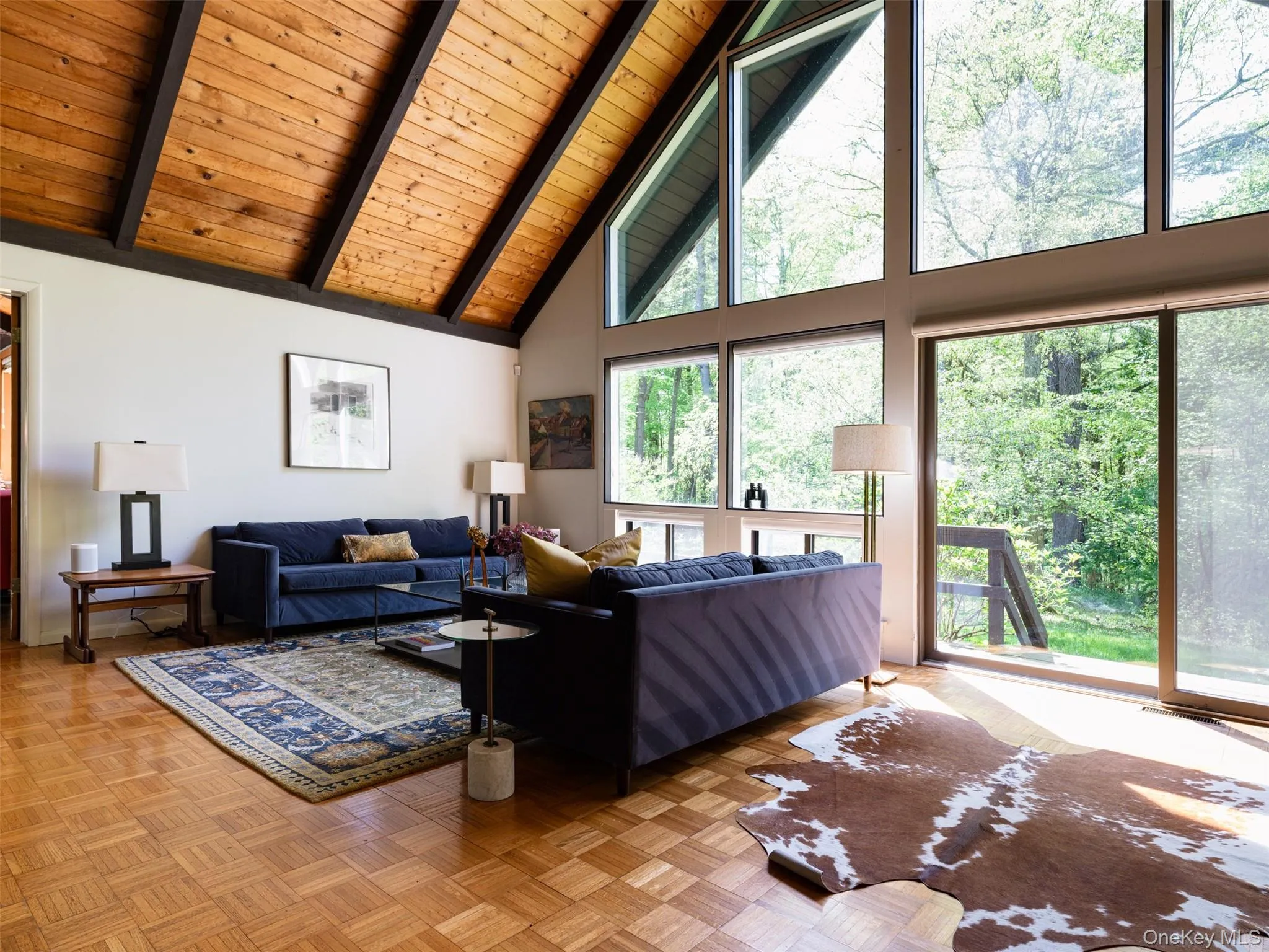 Living area with high vaulted ceiling and a wood ceiling with exposed beams Living area with high vaulted ceiling and a wood ceiling with exposed beams