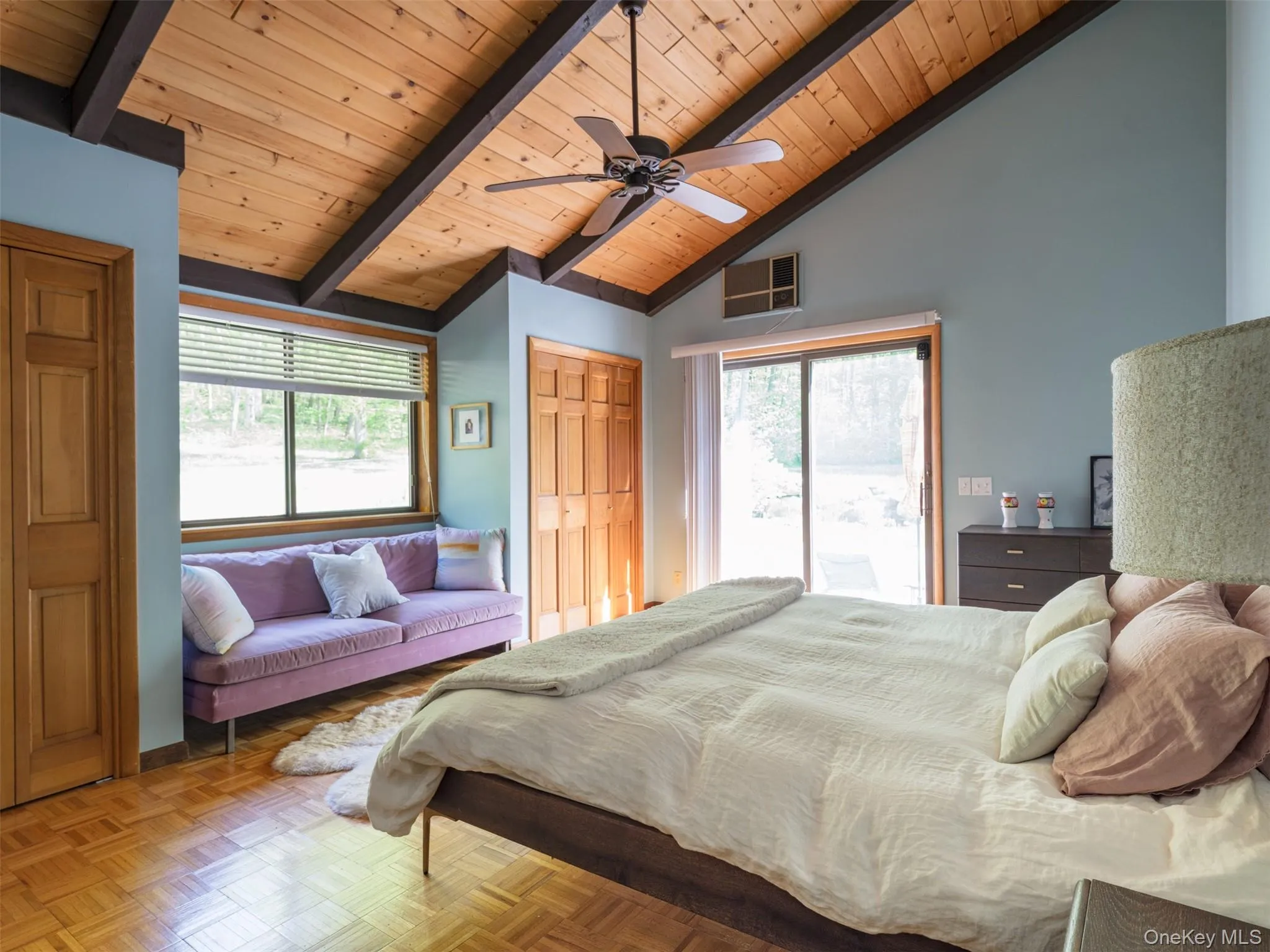 Bedroom featuring access to outside, a wooden ceiling with exposed beams, a ceiling fan, multiple closets, and high vaulted ceiling Bedroom featuring access to outside, a wooden ceiling with exposed beams, a ceiling fan, multiple closets, and high vaulted ceiling