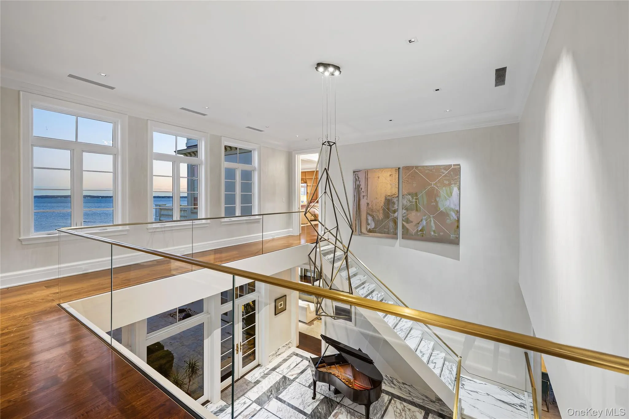 Staircase featuring ornamental molding and a water view Staircase featuring ornamental molding and a water view