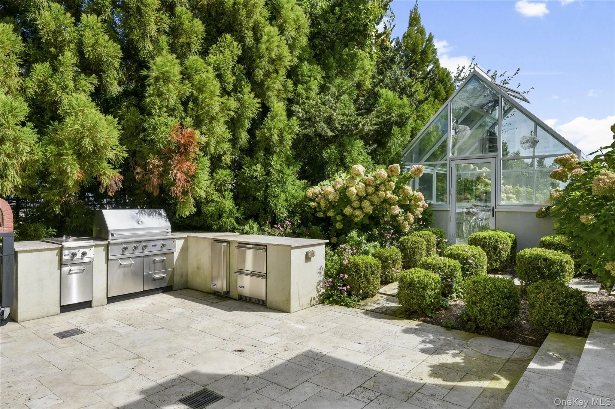 View of patio / terrace featuring a greenhouse, area for grilling View of patio / terrace featuring a greenhouse, area for grilling