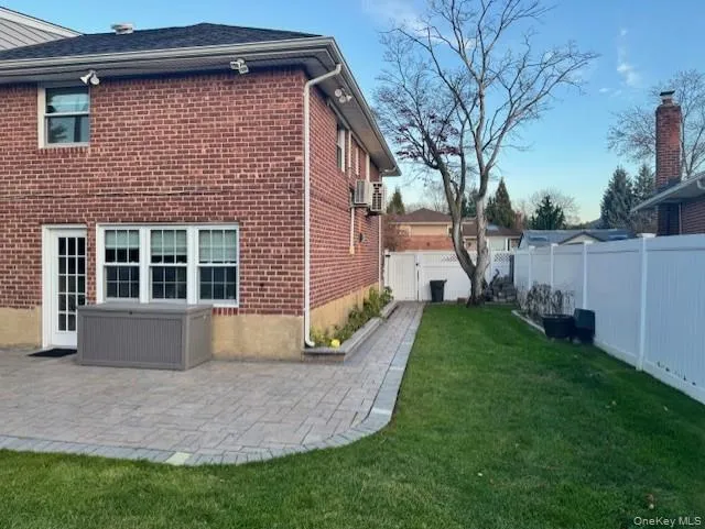 View of home's exterior featuring brick siding and a patio area View of home's exterior featuring brick siding and a patio area