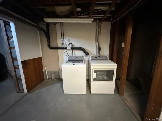 Laundry room with unfinished concrete flooring and separate washer and dryer Laundry room with unfinished concrete flooring and separate washer and dryer