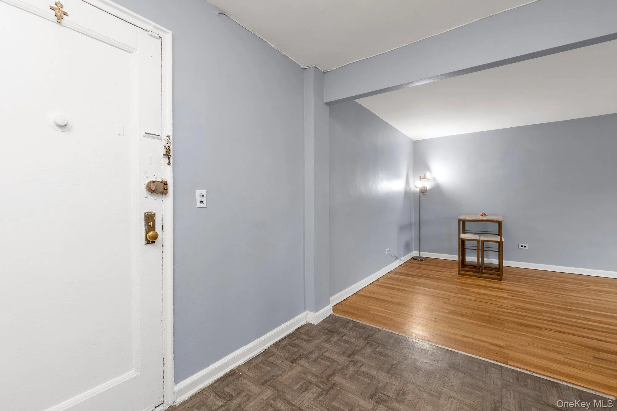 Empty room featuring parquet flooring and baseboards Empty room featuring parquet flooring and baseboards